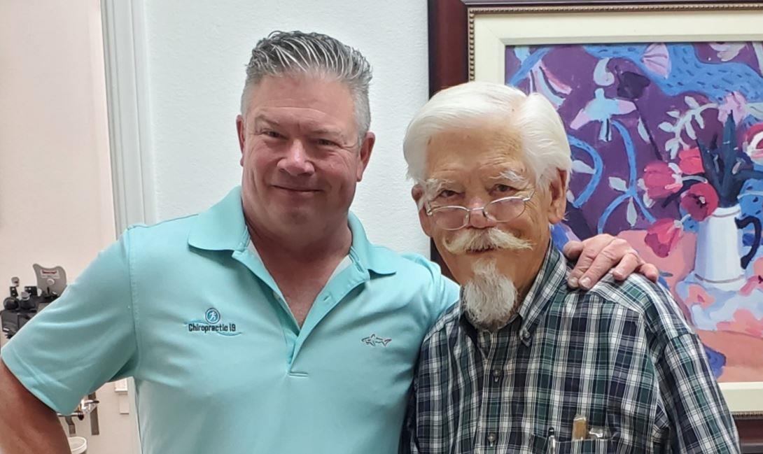 Two men standing together smiling