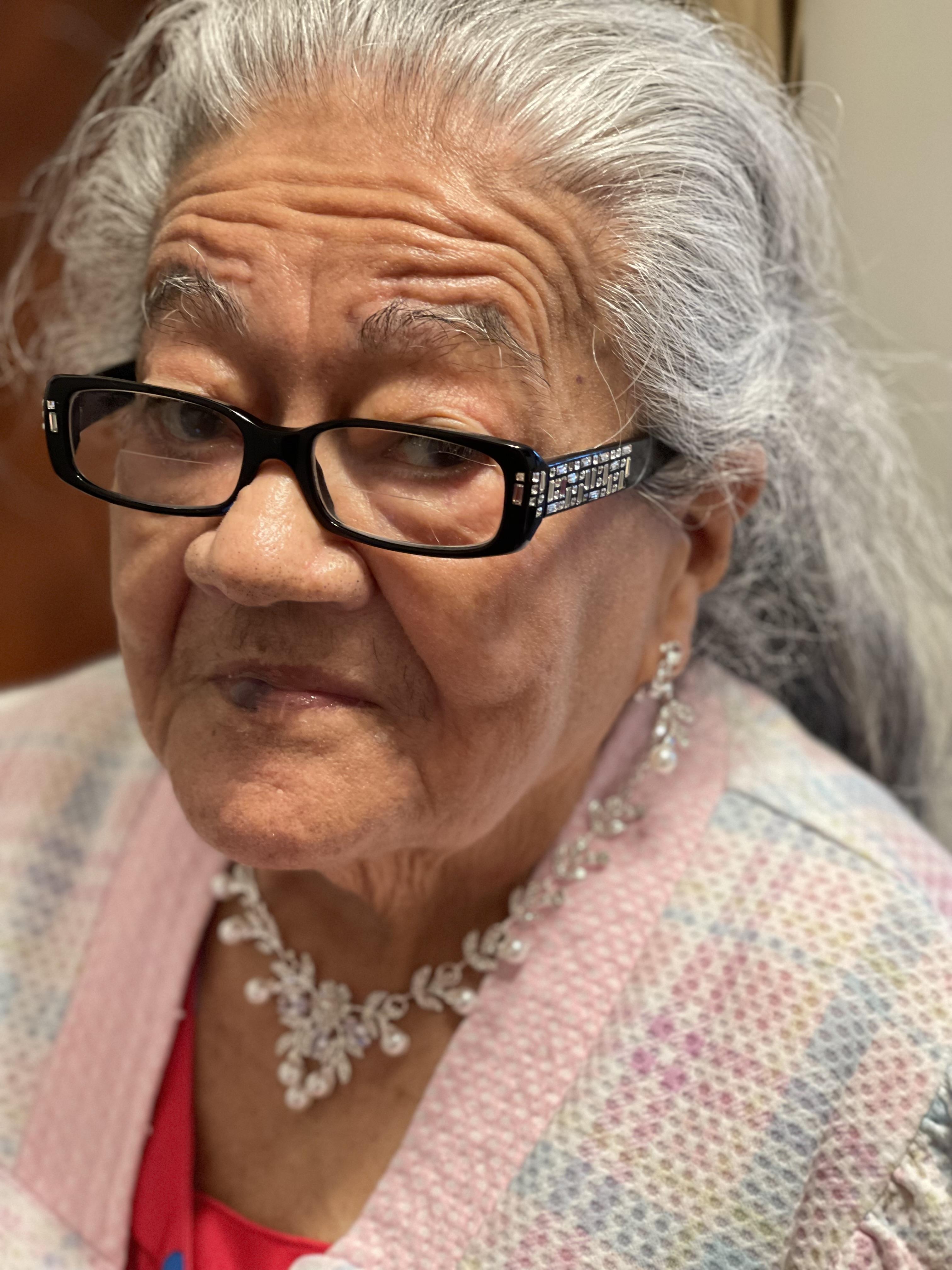 A woman with glasses and a necklace