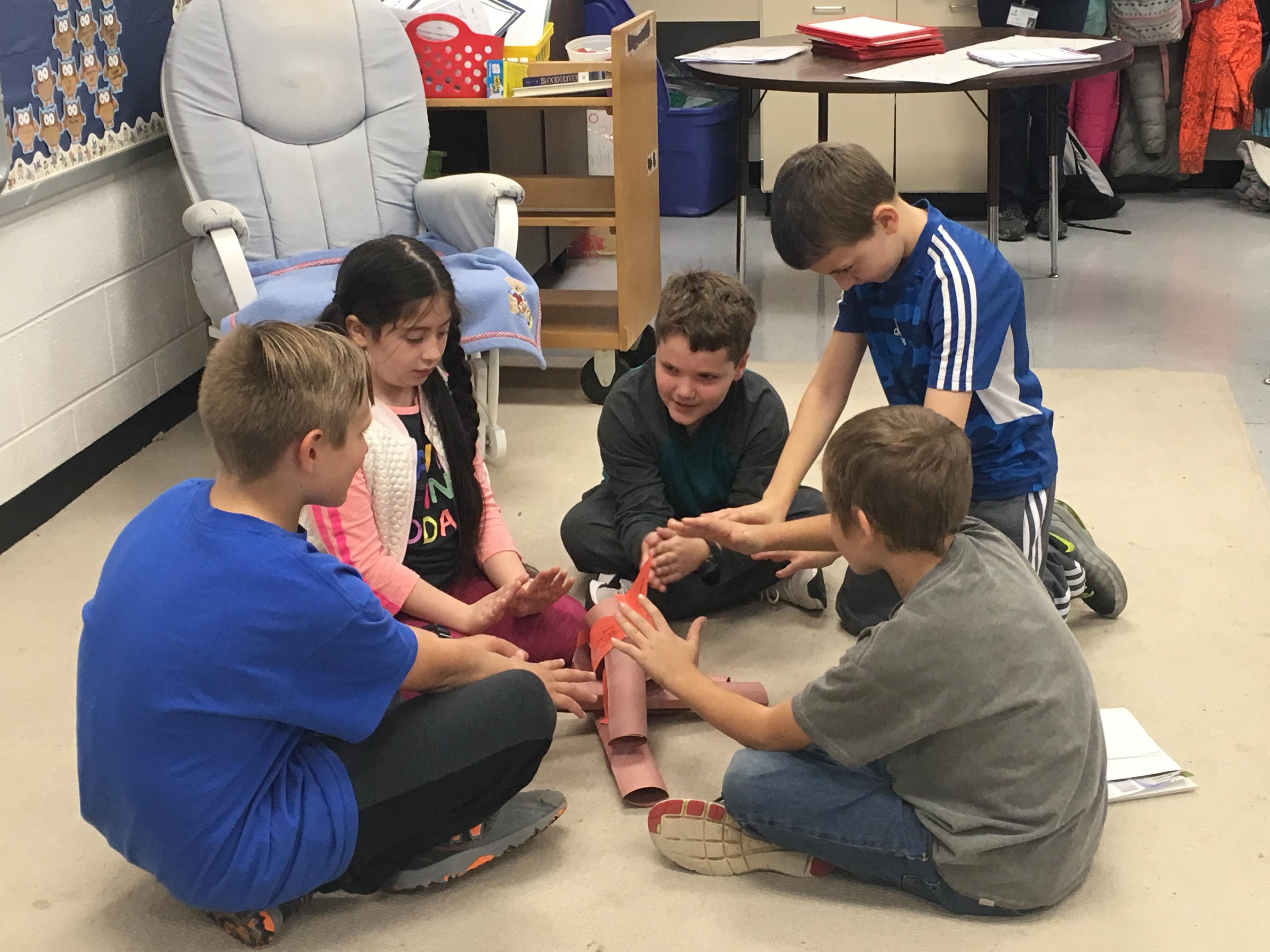 A group of children sitting on the floor