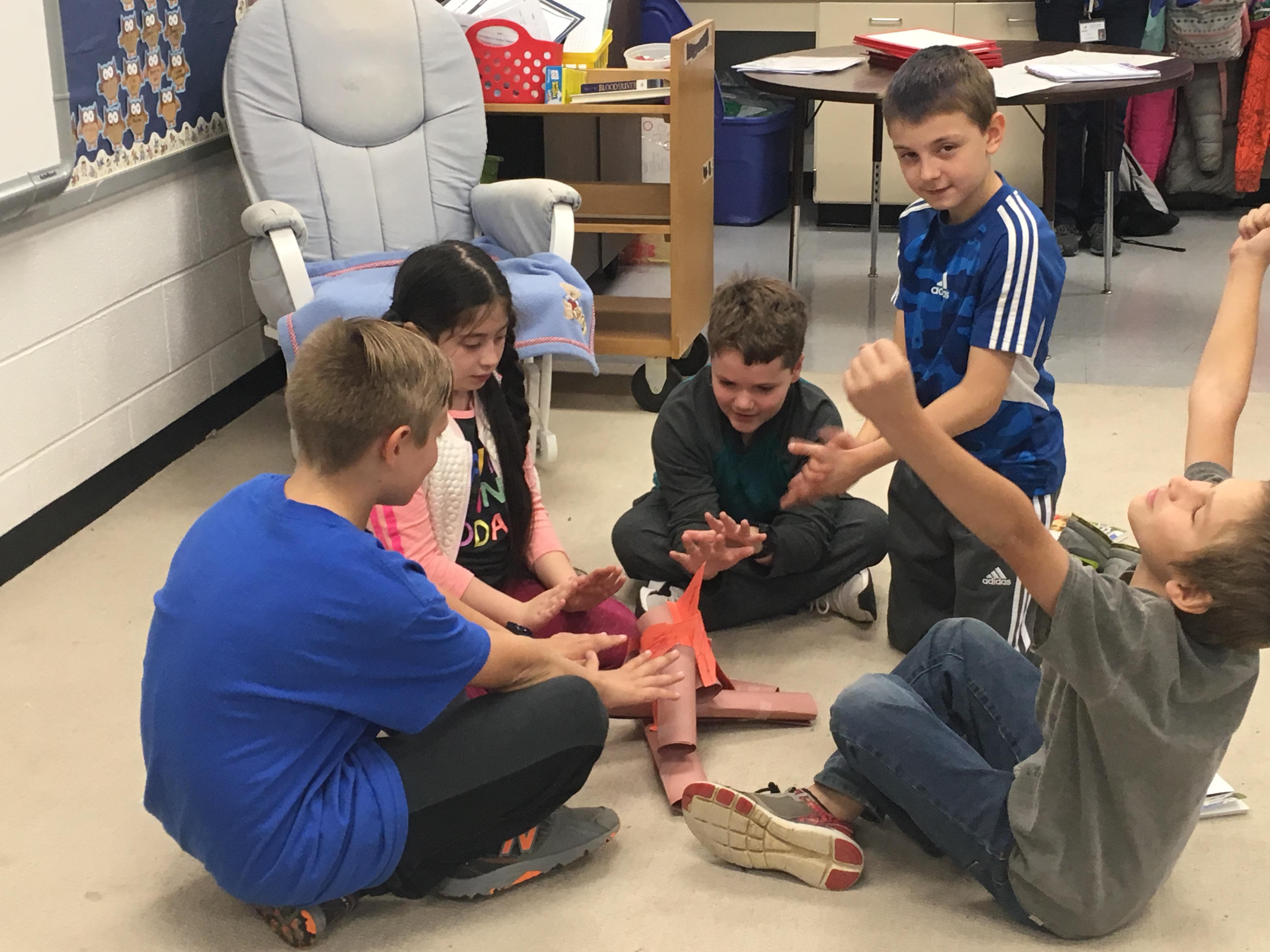 A group of children sitting on the floor