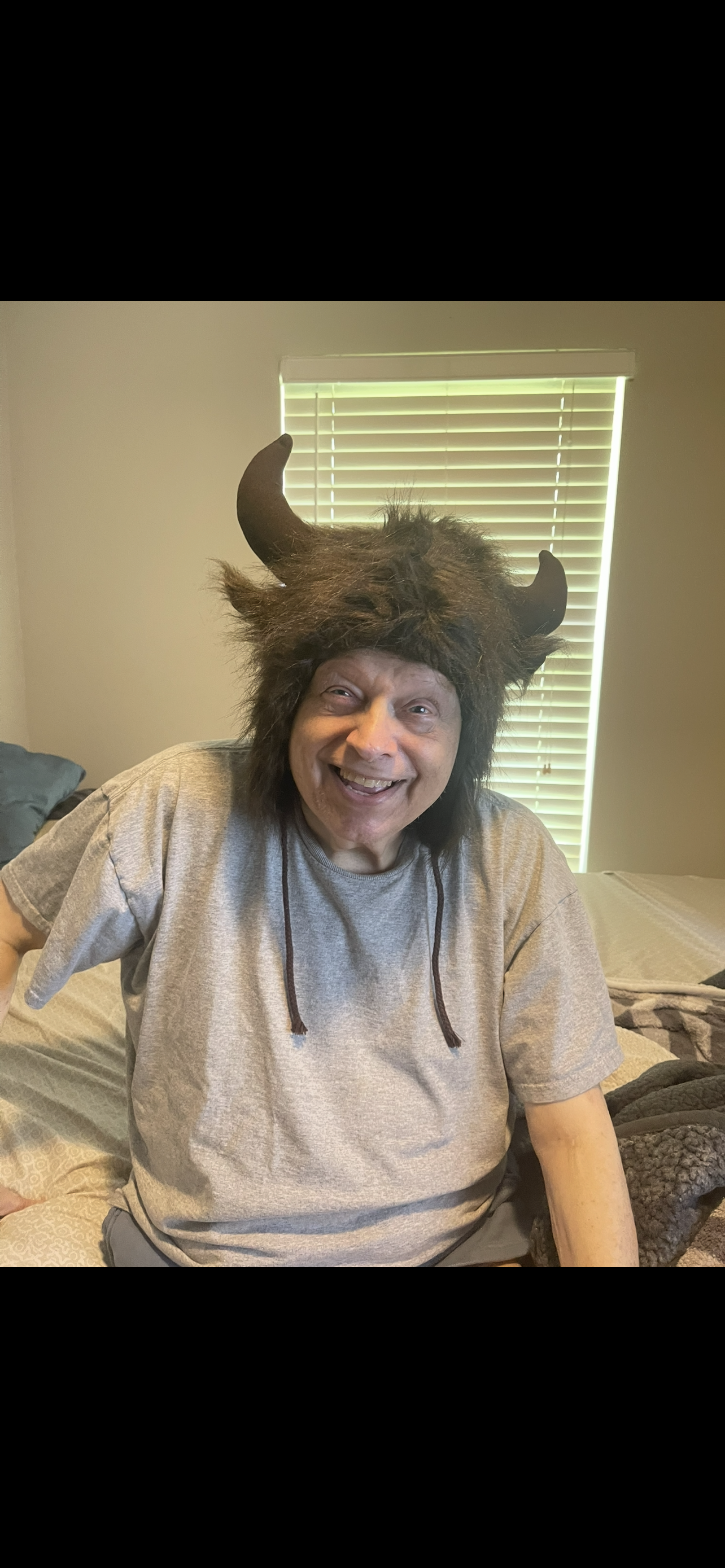 A man wearing a furry hat with horns