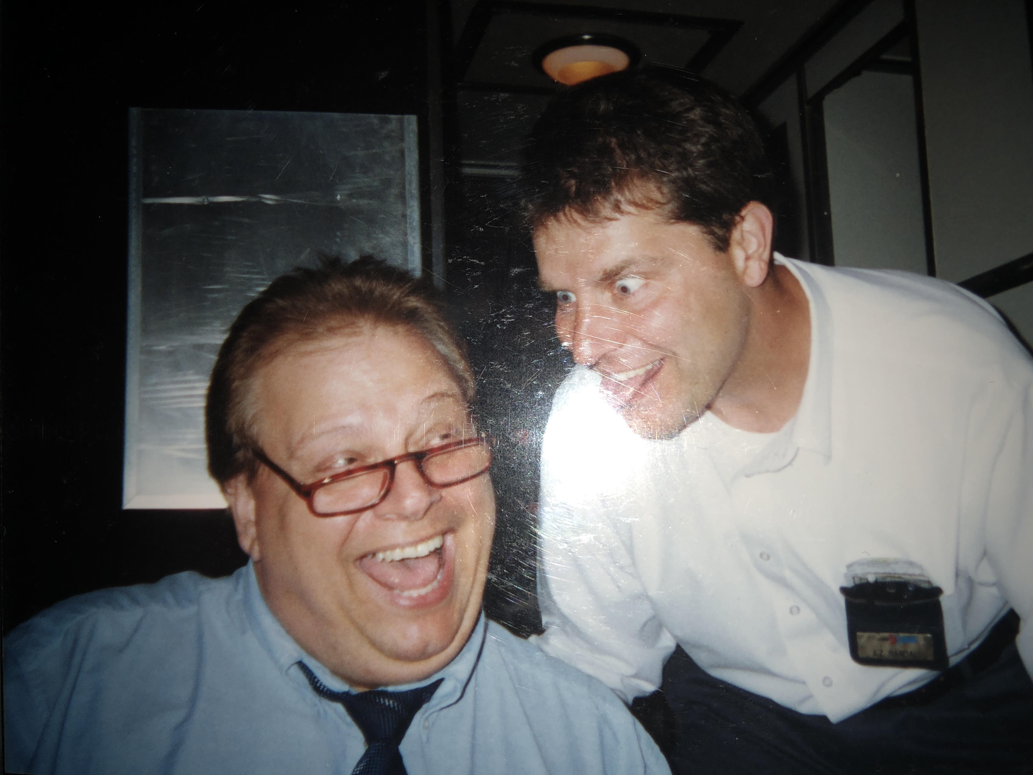 A man laughing next to another man