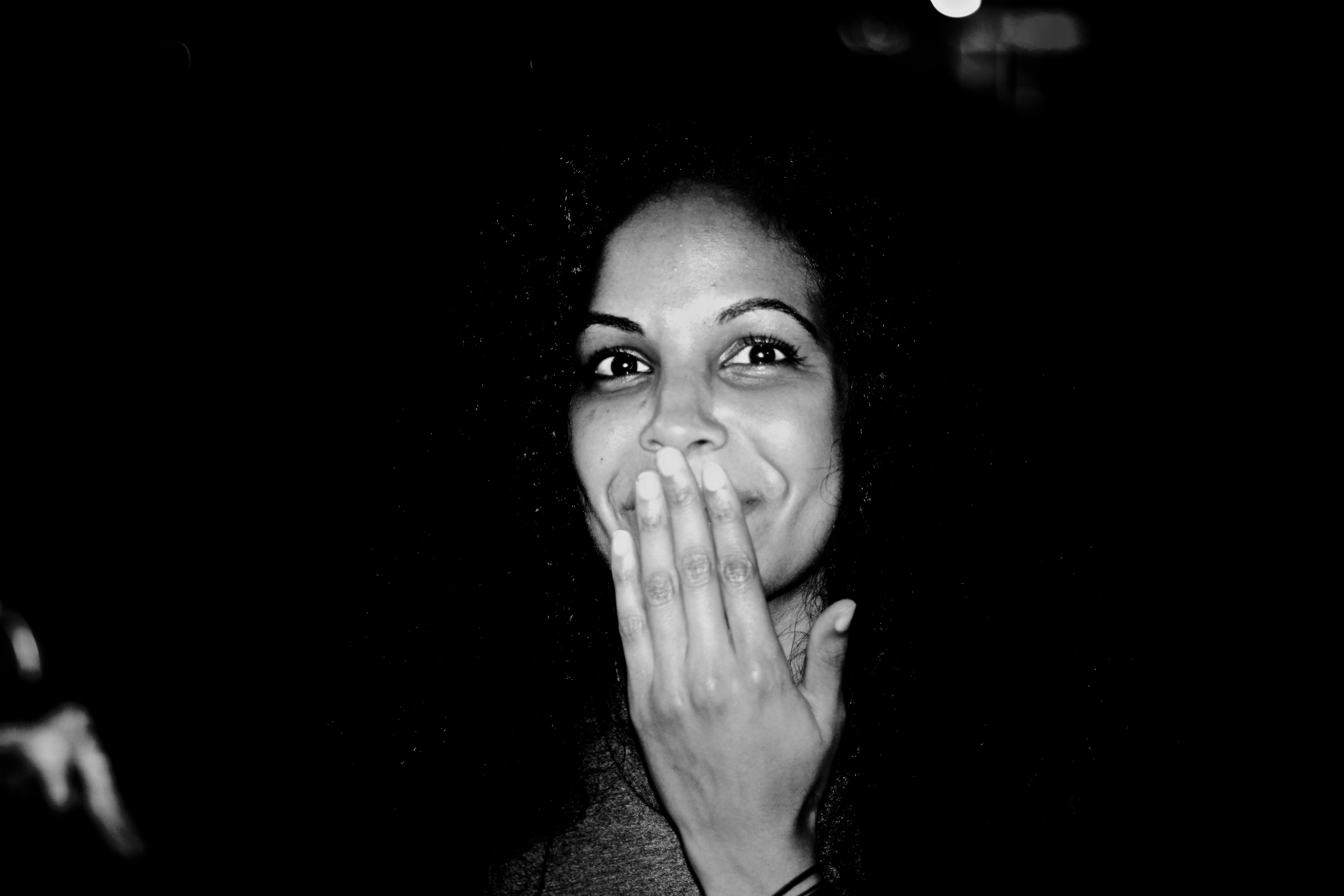 A woman covering her mouth with her hand