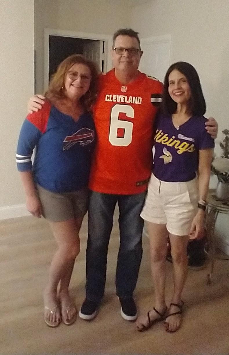 A man with his arms around a man with two women