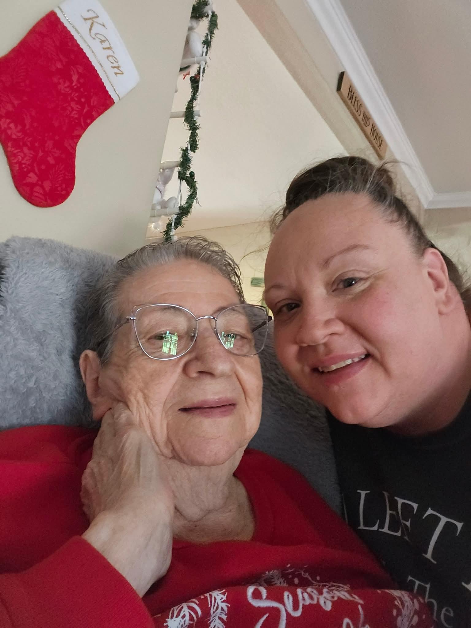 A woman taking a selfie with an older woman