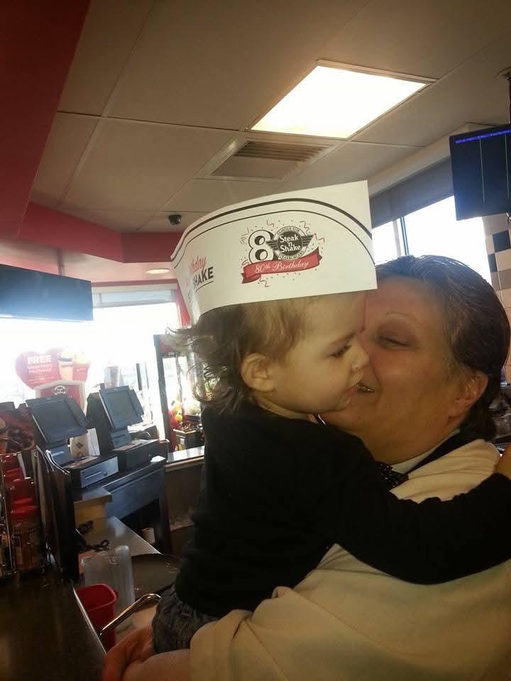 A woman kissing a child