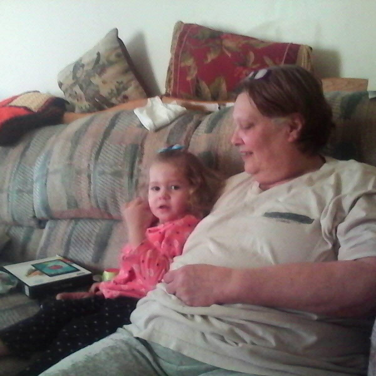 A woman and a child sitting on a couch