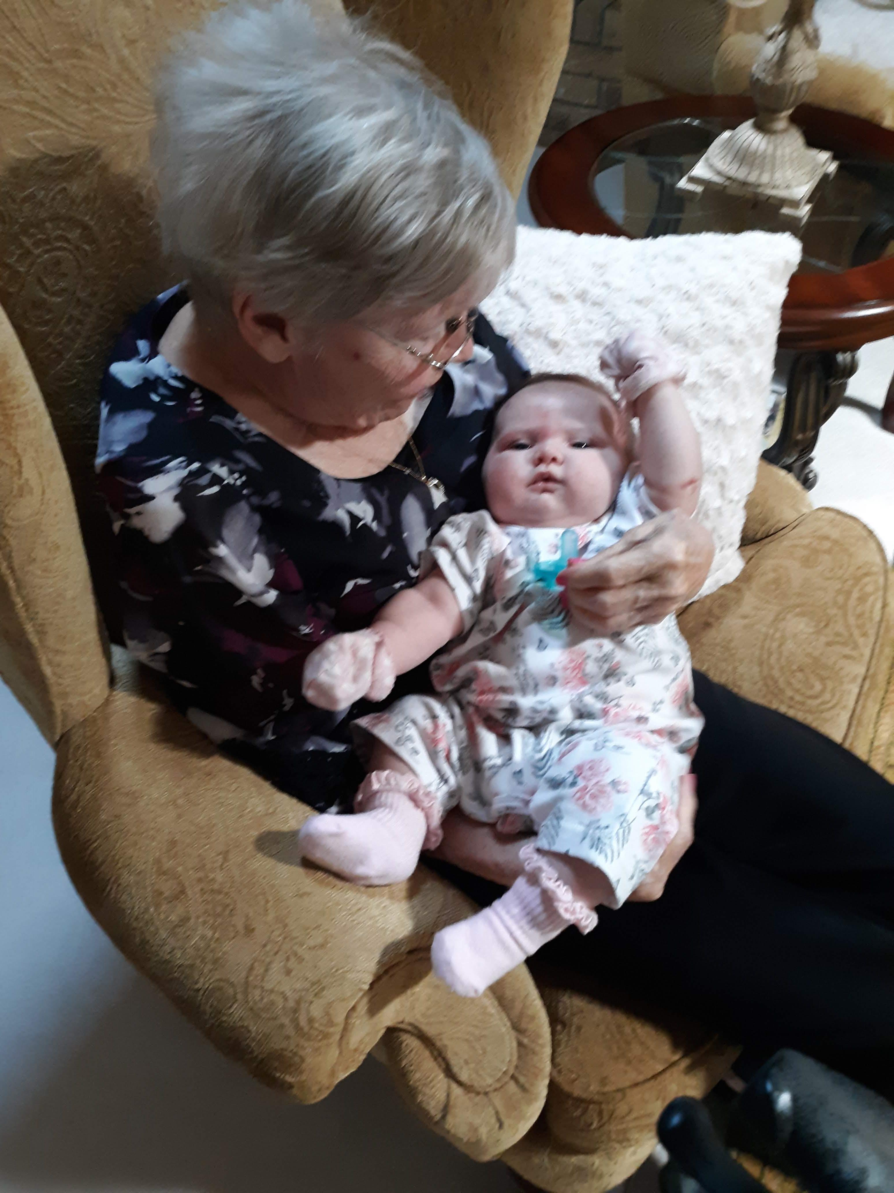 An old woman holding a baby