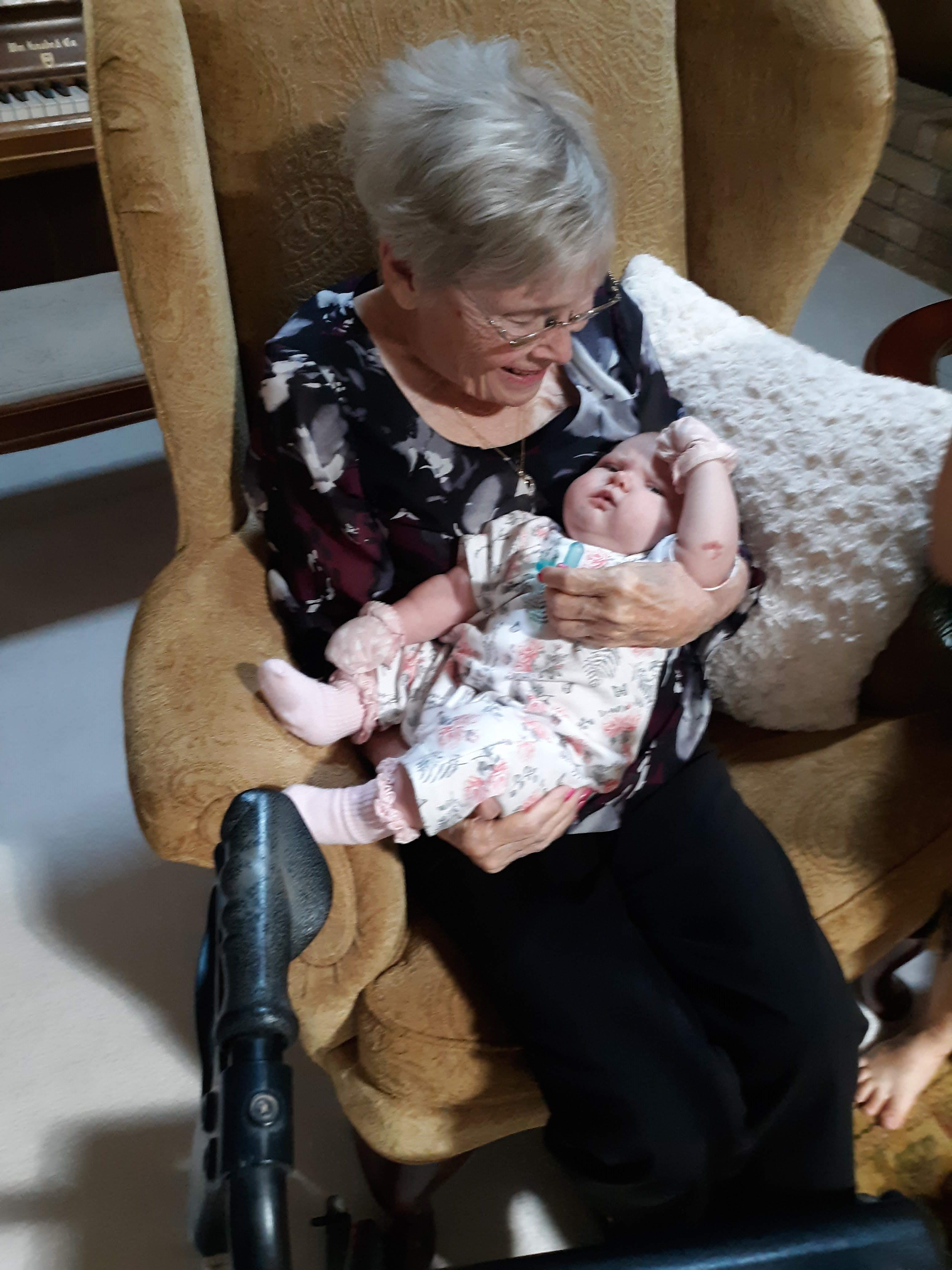 An old woman holding a baby