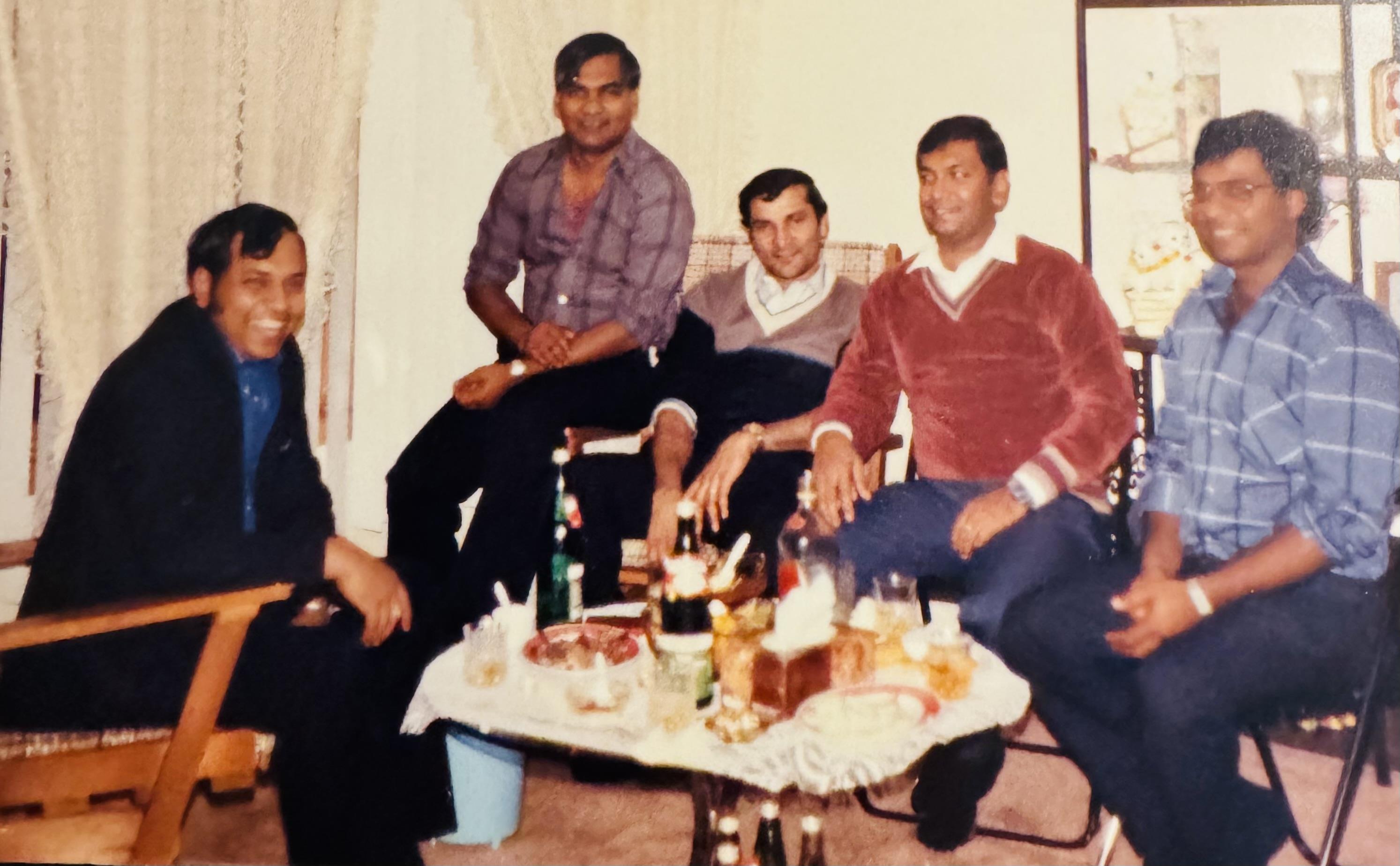 A group of men sitting around a table