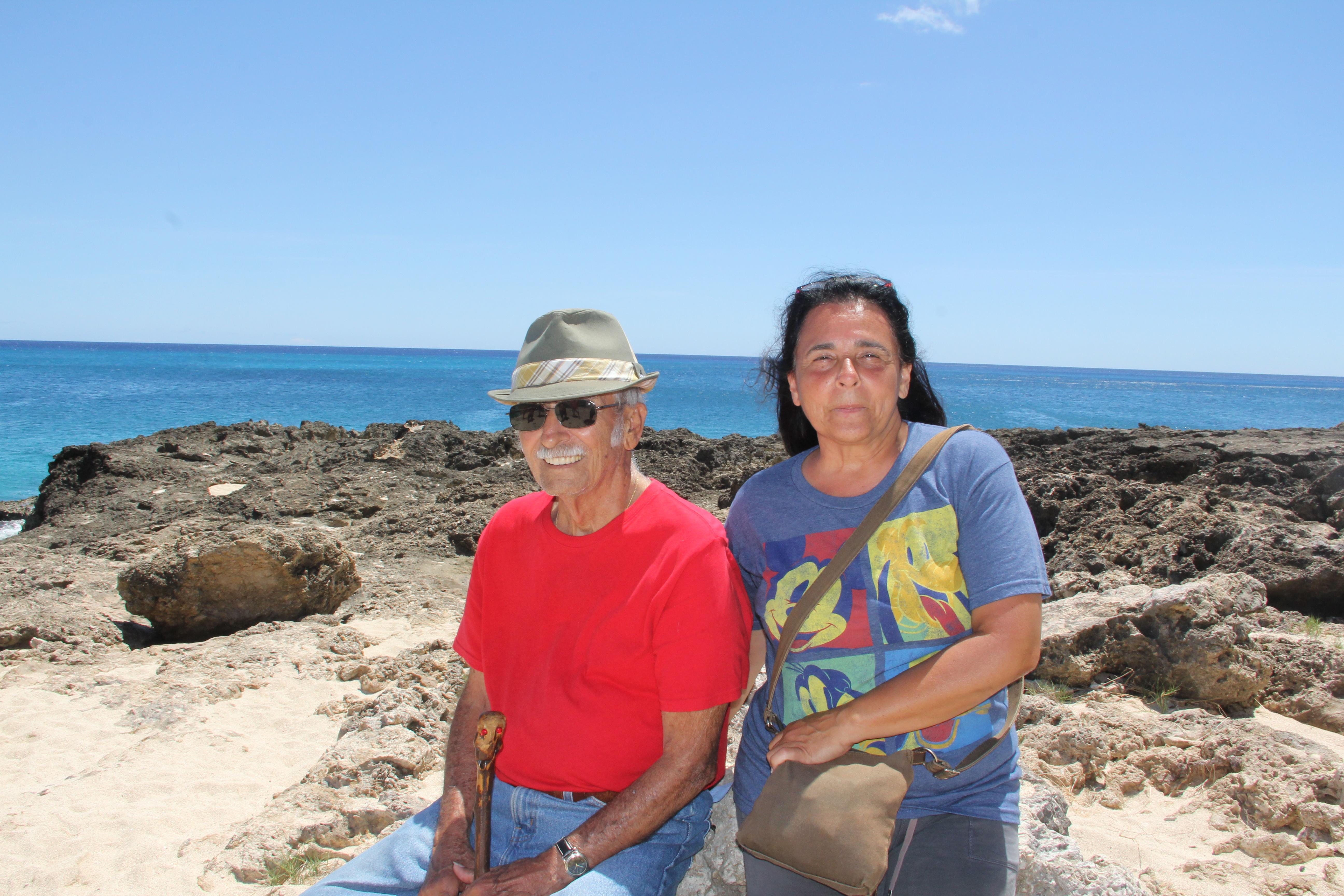 A man and woman sitting on rocks