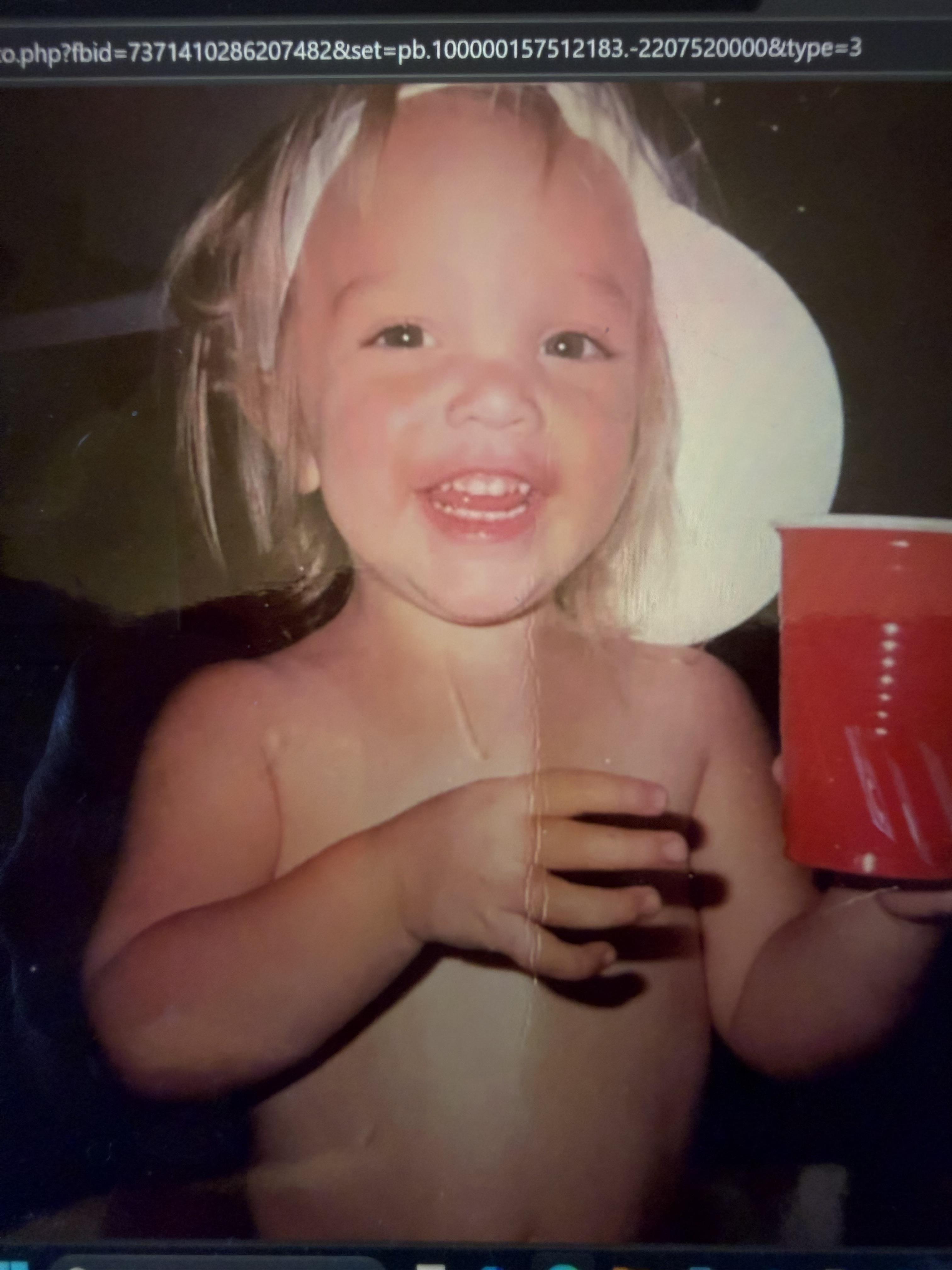 A child holding a red cup