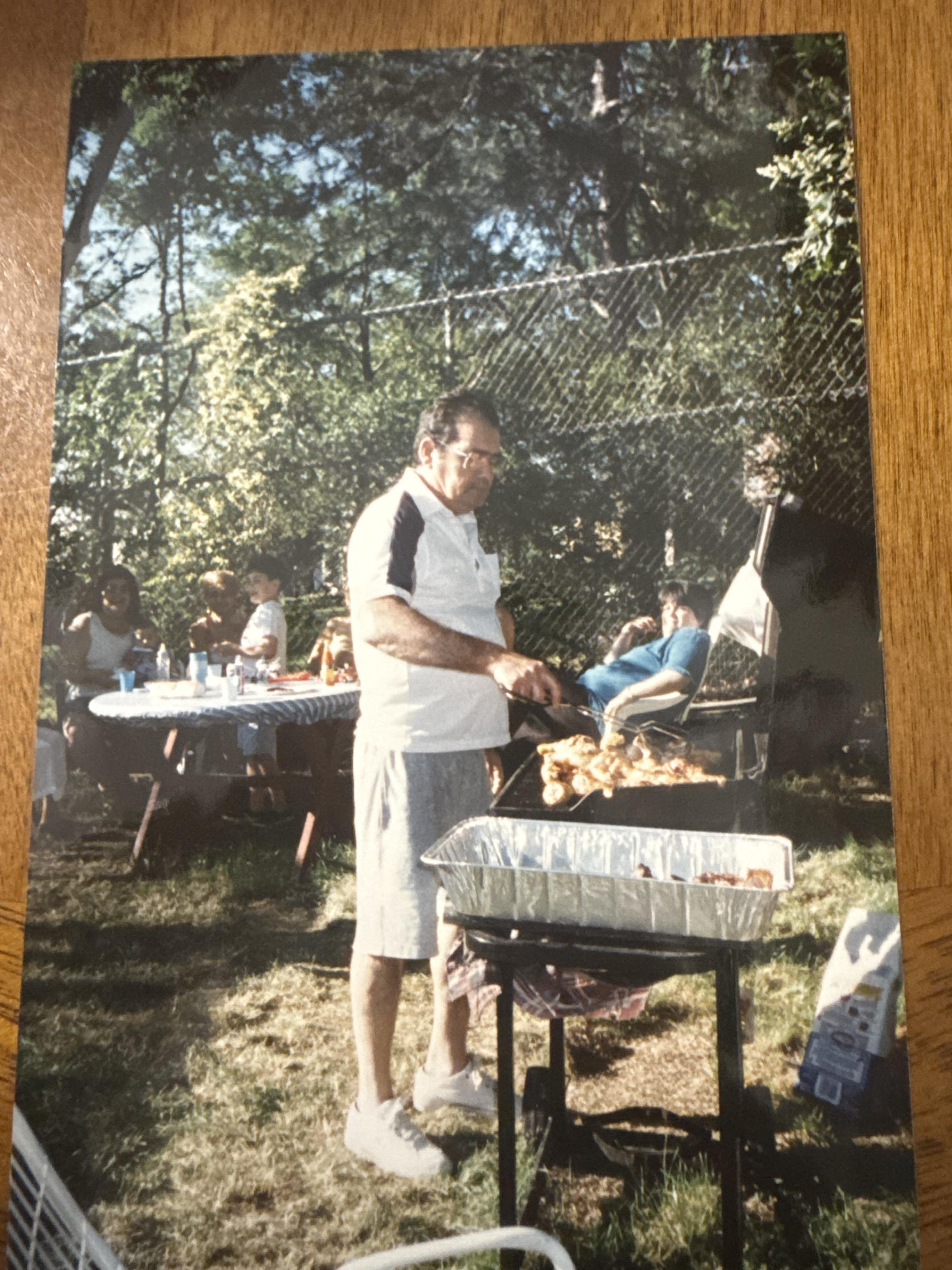A man cooking food on a grill