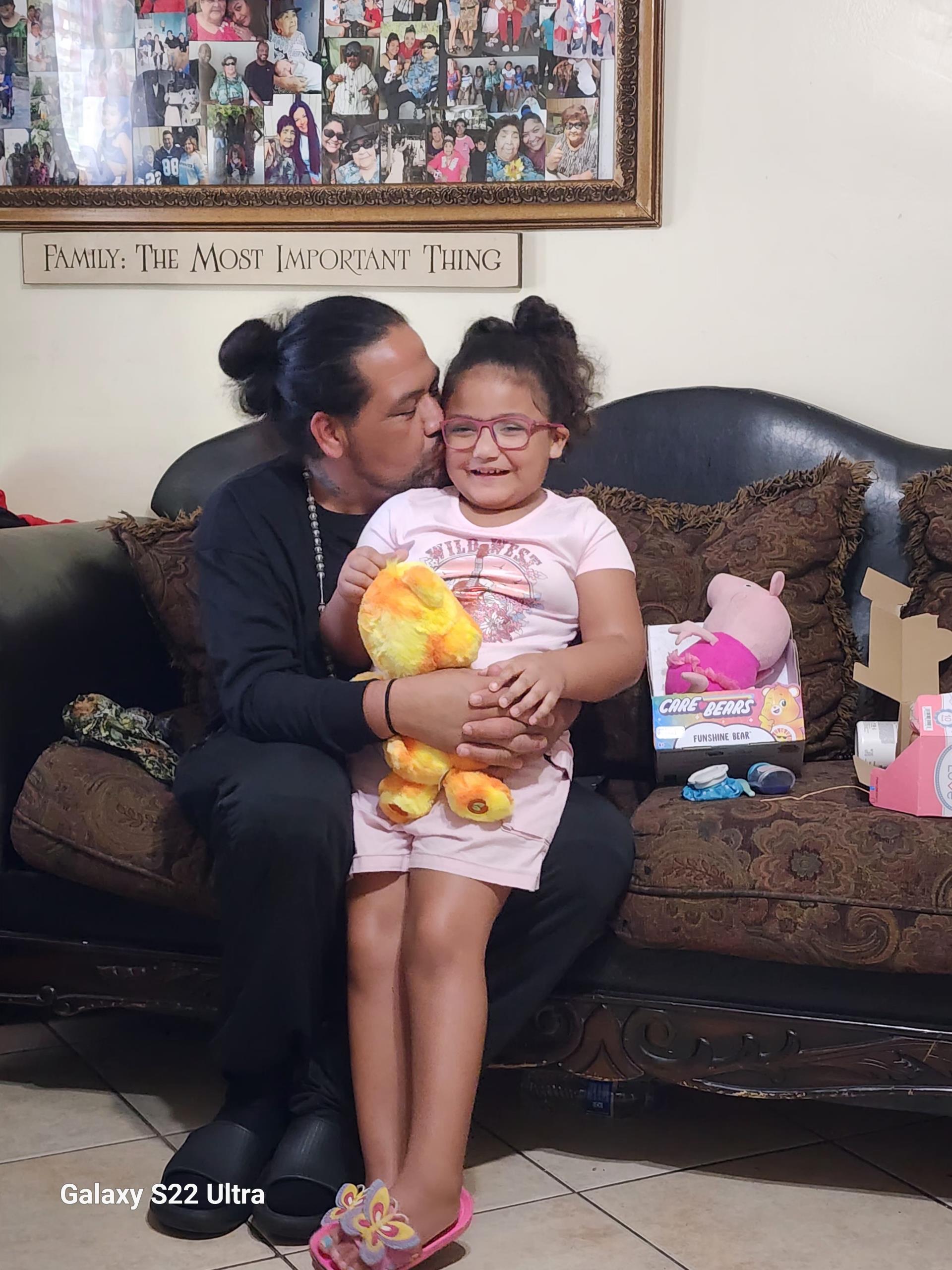 A man kissing a girl on a couch