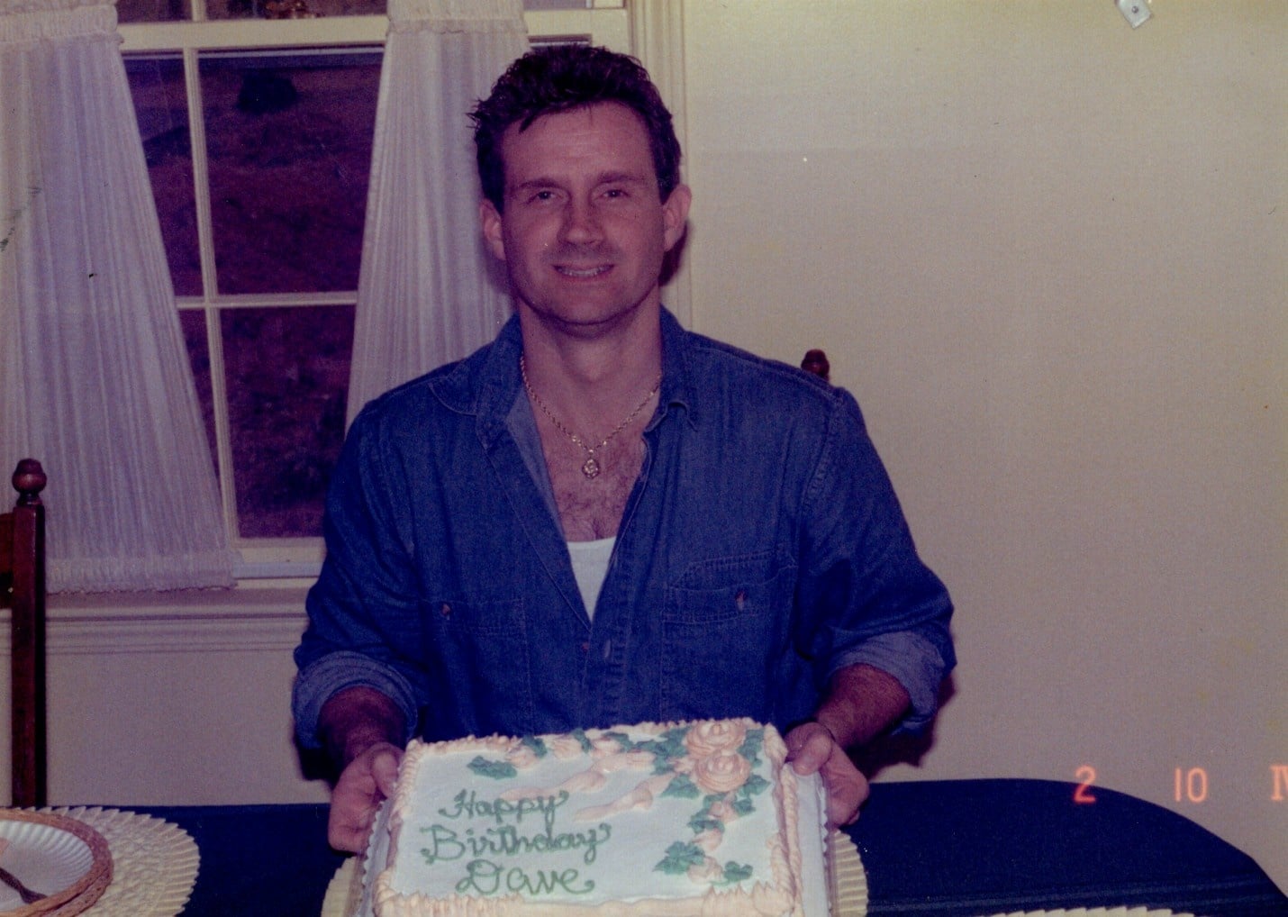 A man holding a birthday cake