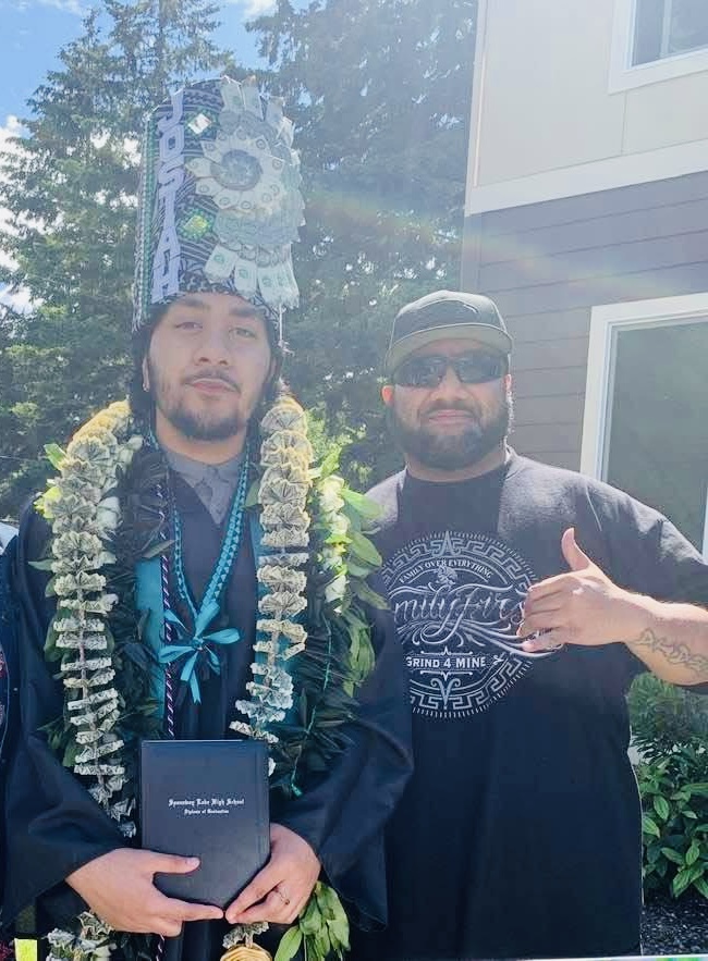 A man wearing a lei and a hat