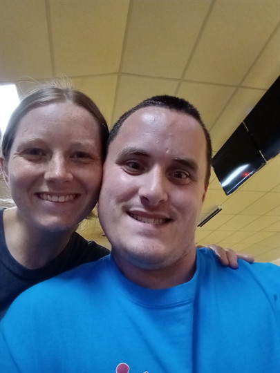 A man and woman smiling for a selfie
