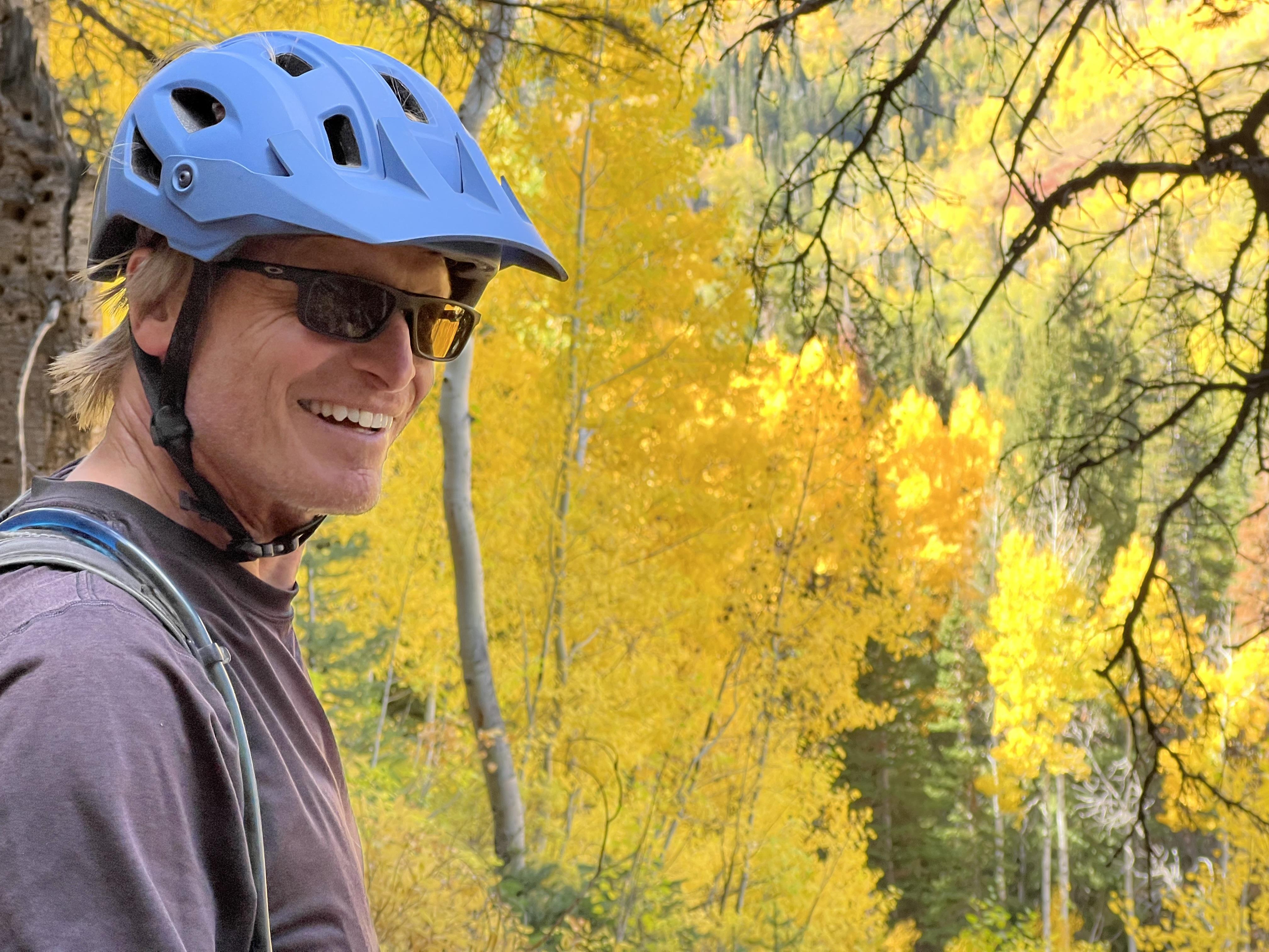 A man wearing a helmet and sunglasses
