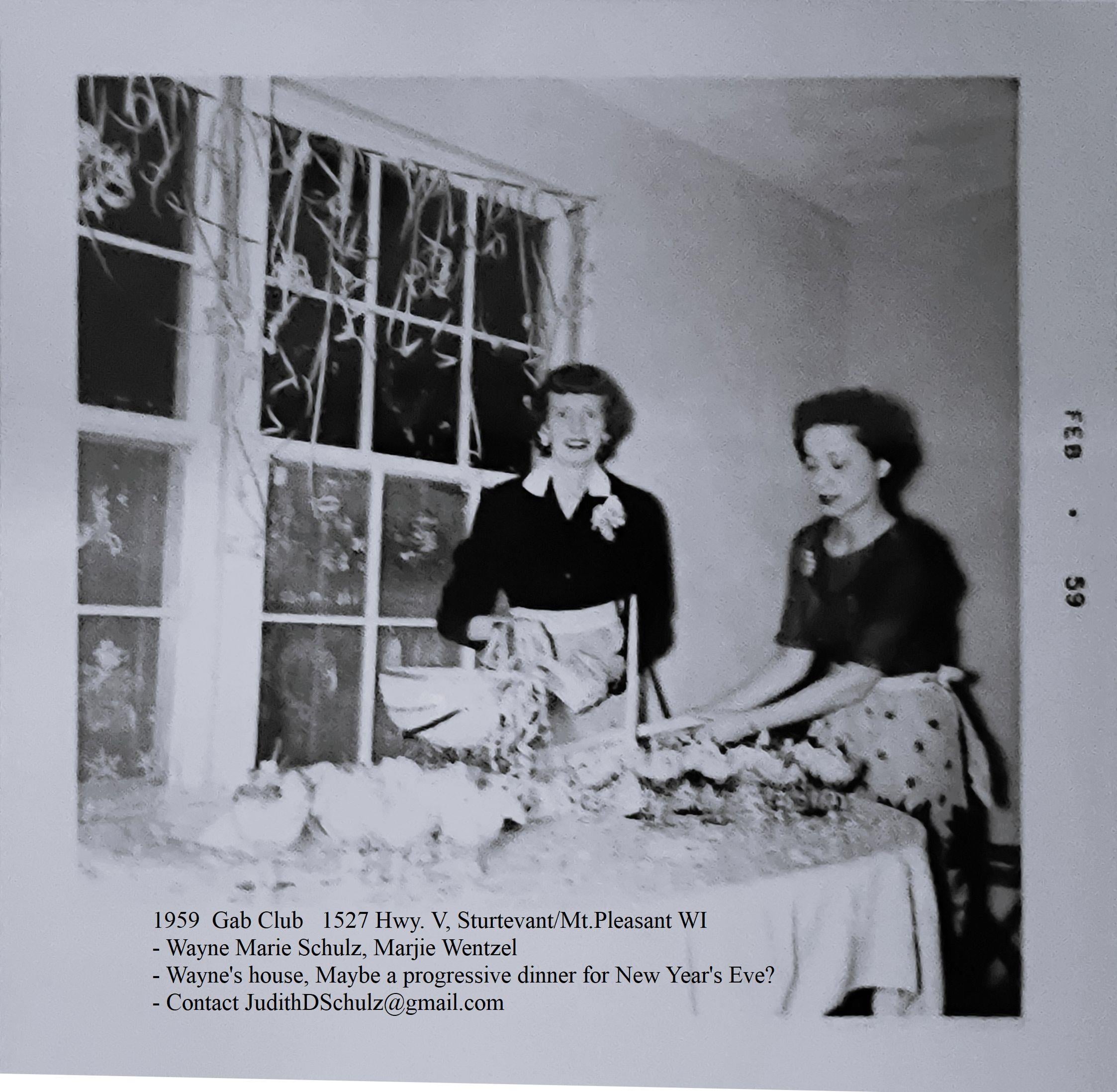 A couple of women standing at a table