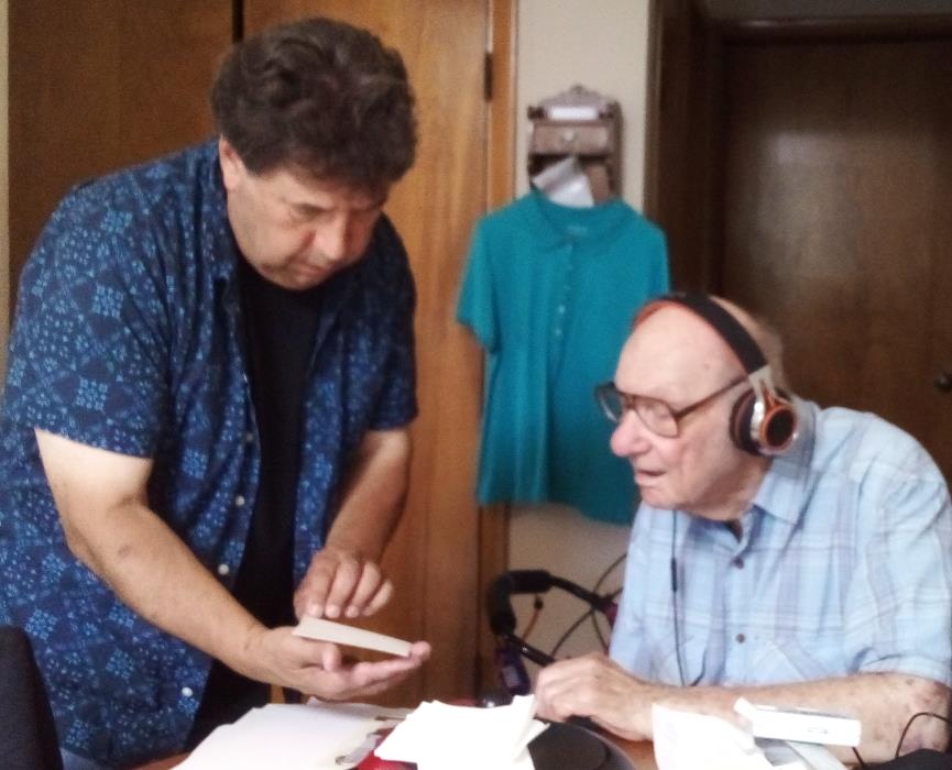 Two men looking at papers