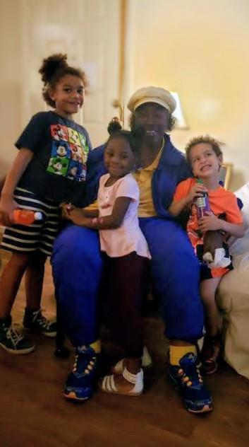 A man and children posing for a picture