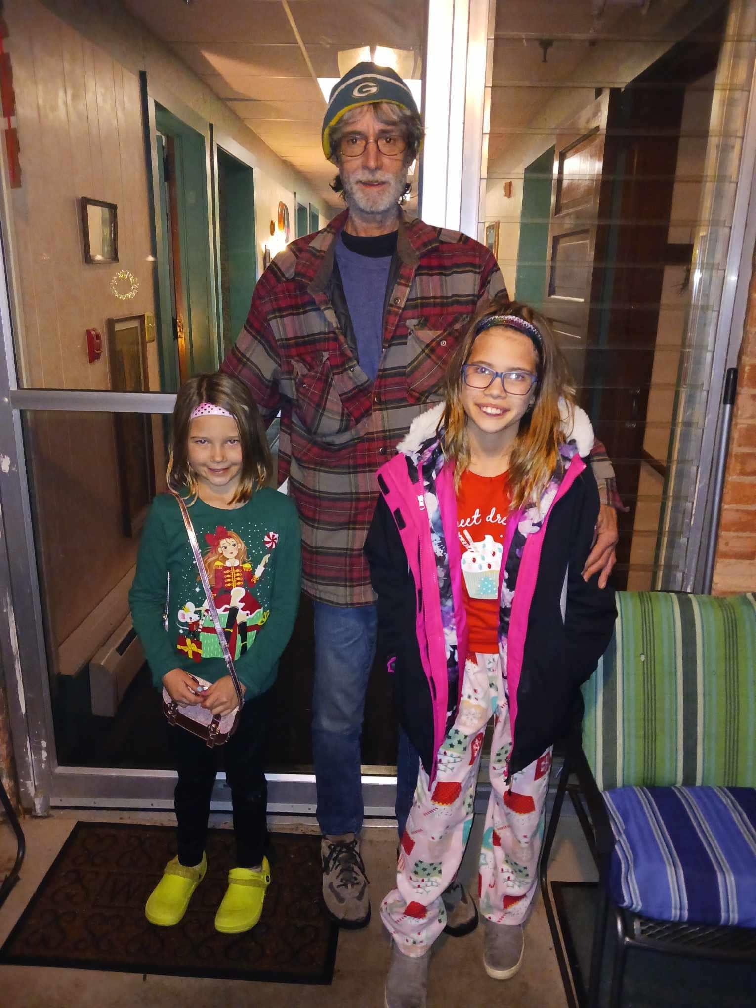 A man standing with two girls