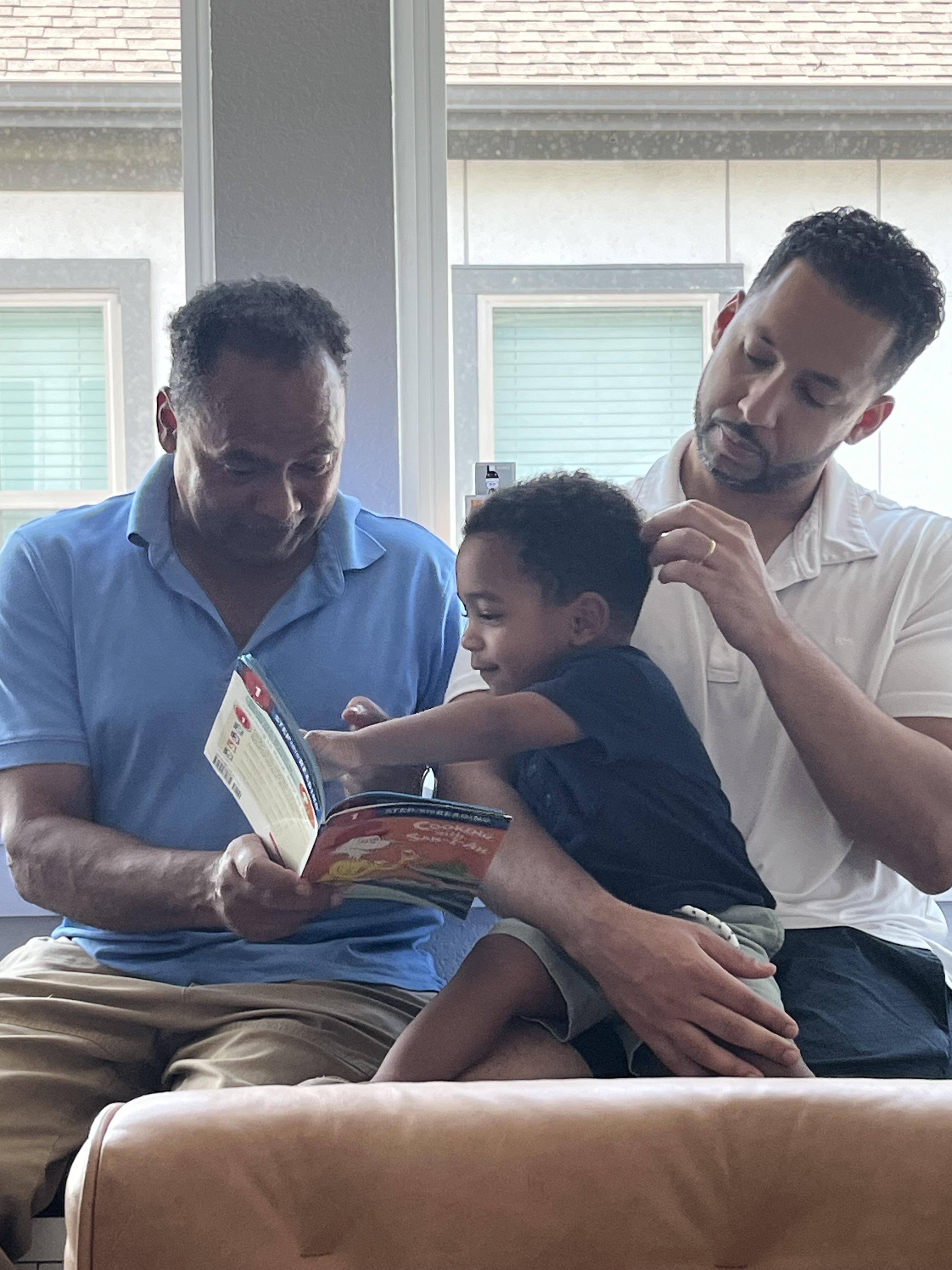 A man and a child reading a book
