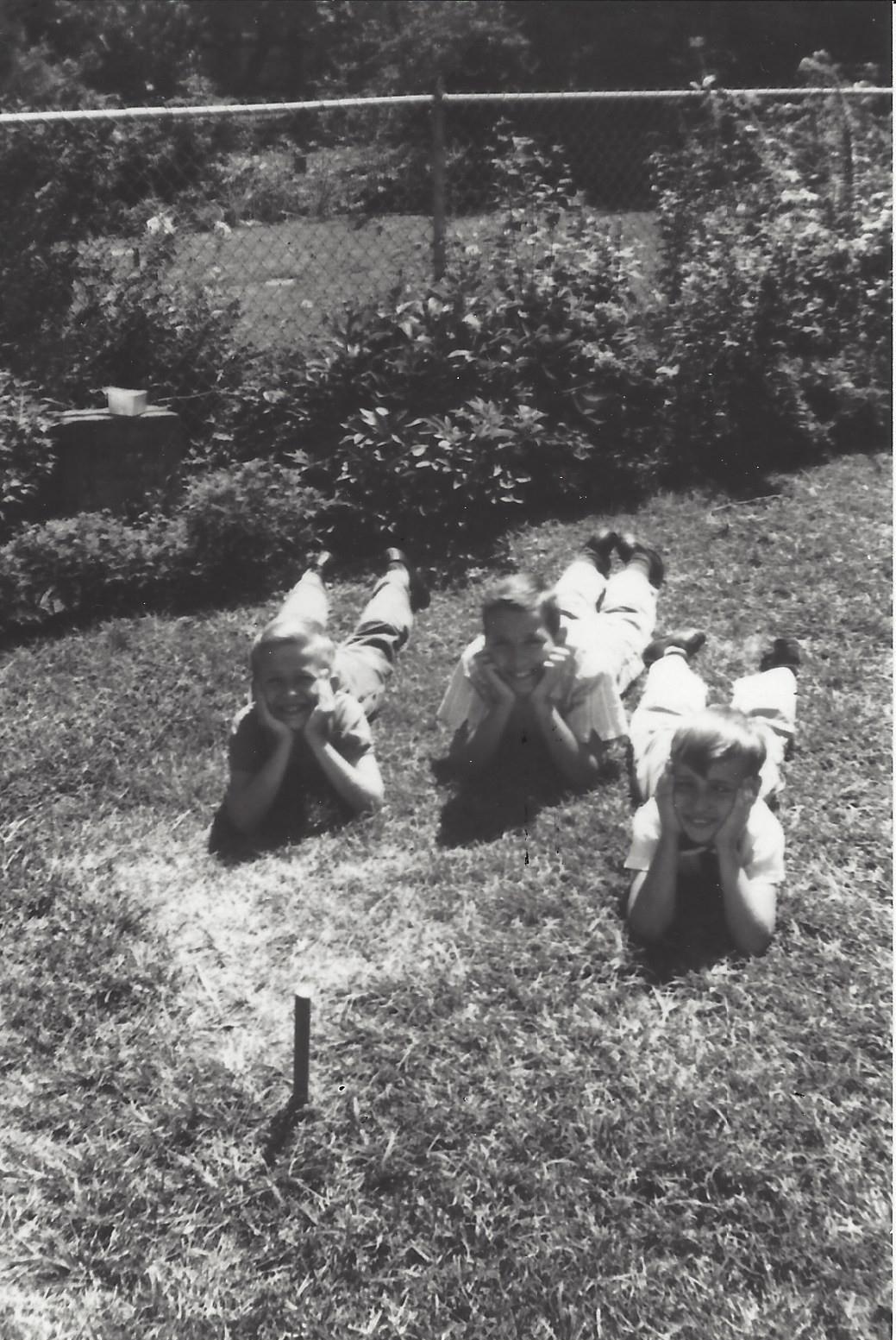 A group of children lying on the grass