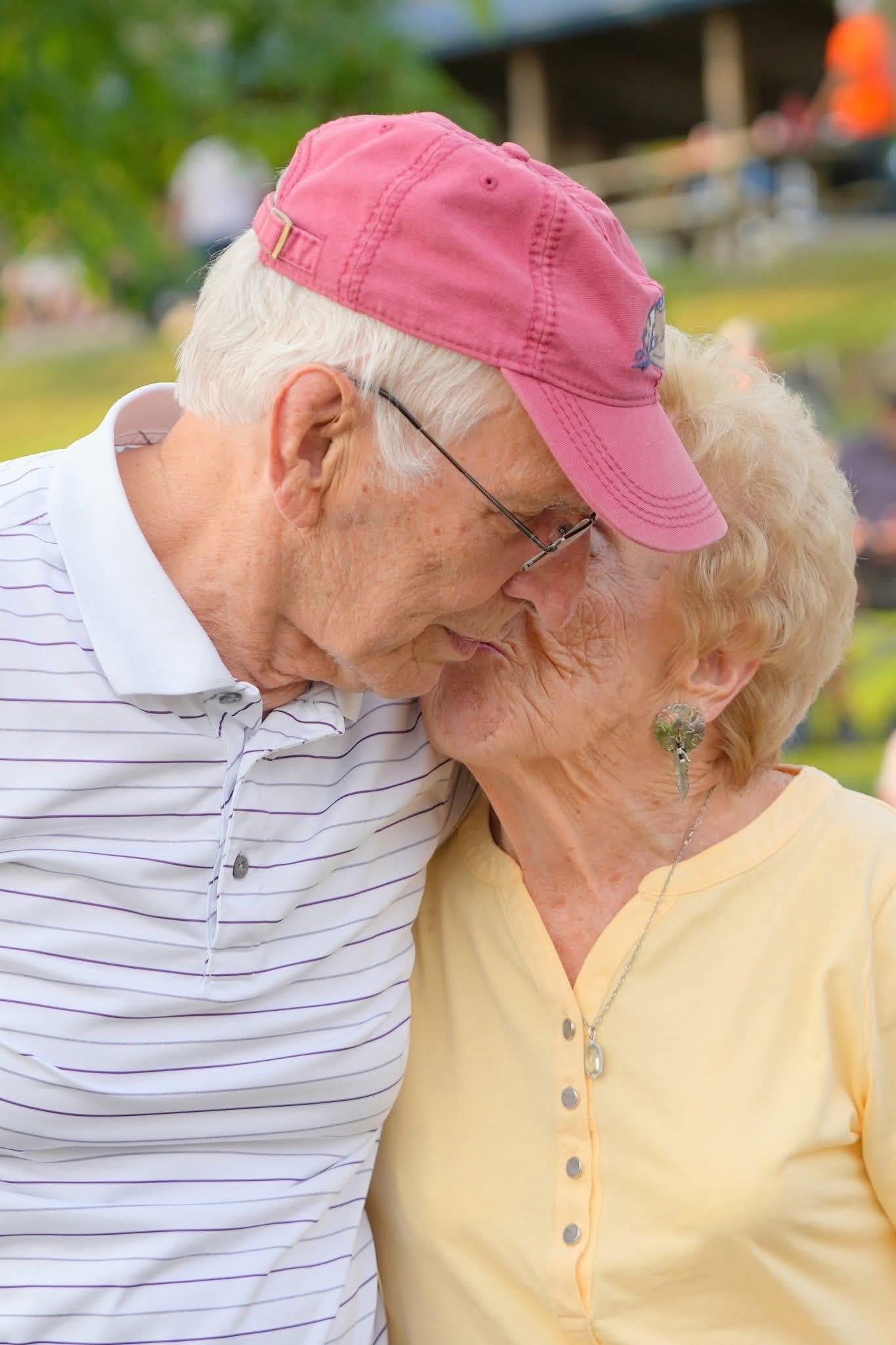 An older man and woman kissing