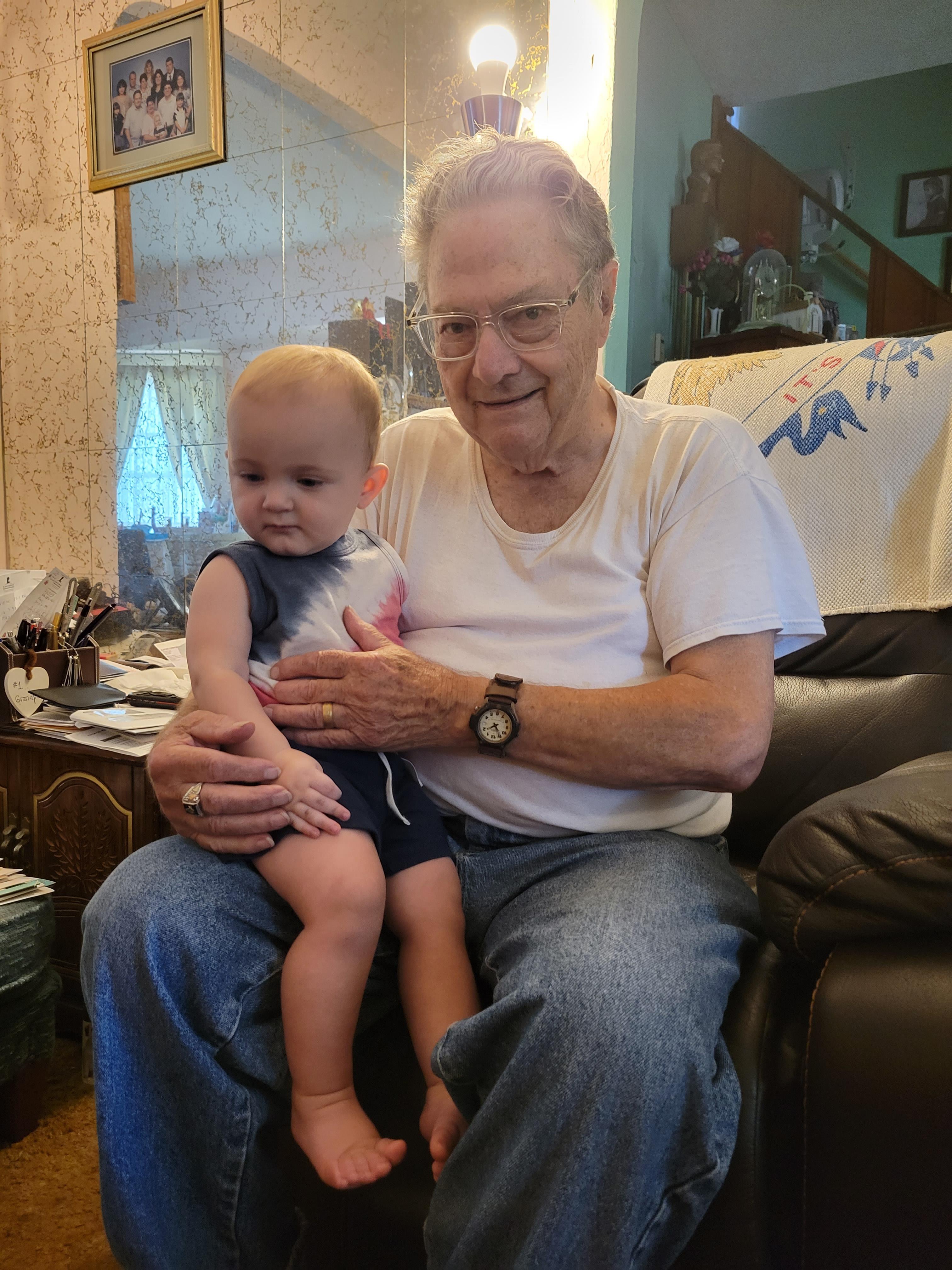 An old man holding a baby