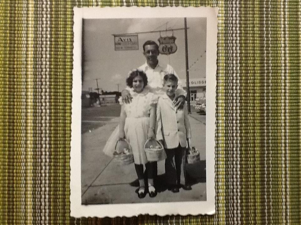 A man and two children holding baskets