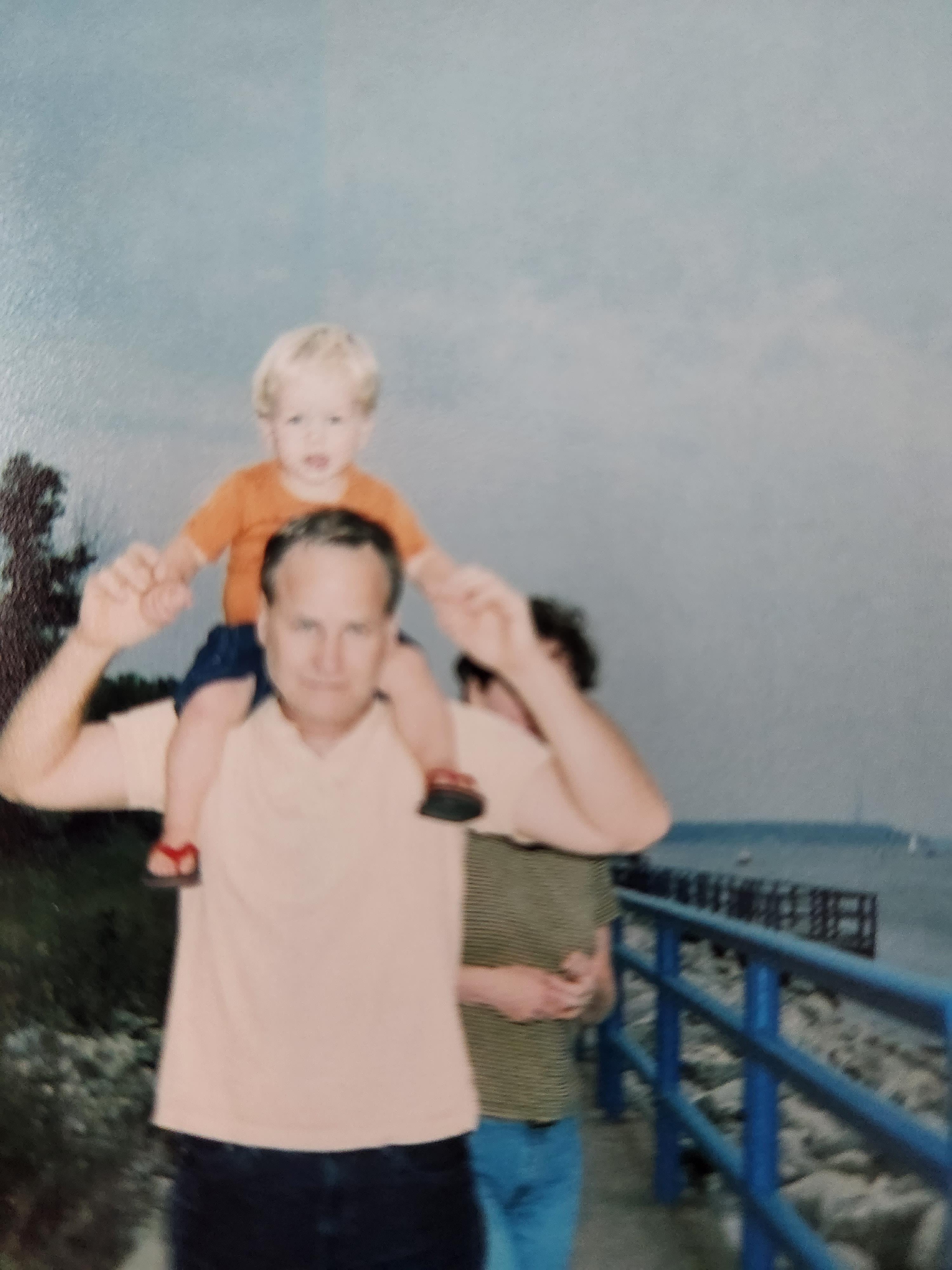 A man holding a child on his shoulders