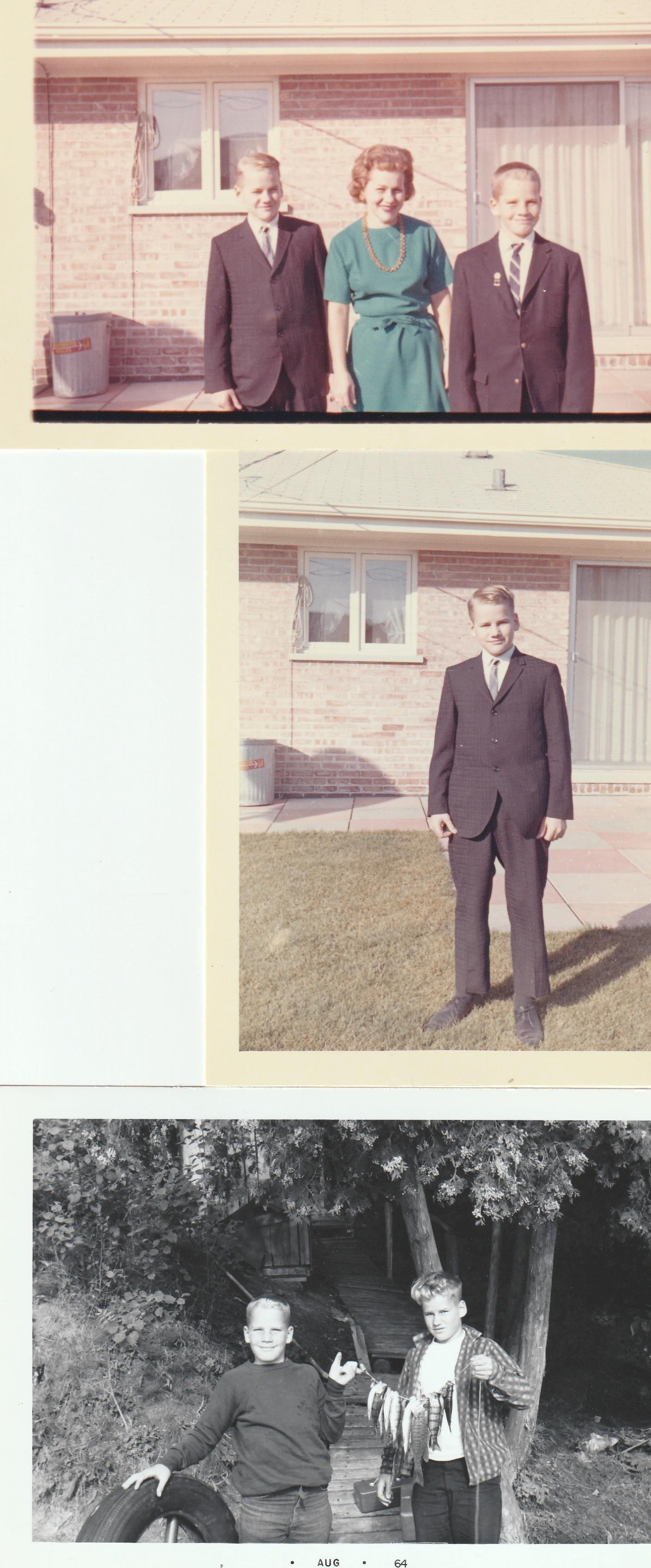 A boy in a suit standing in front of a house