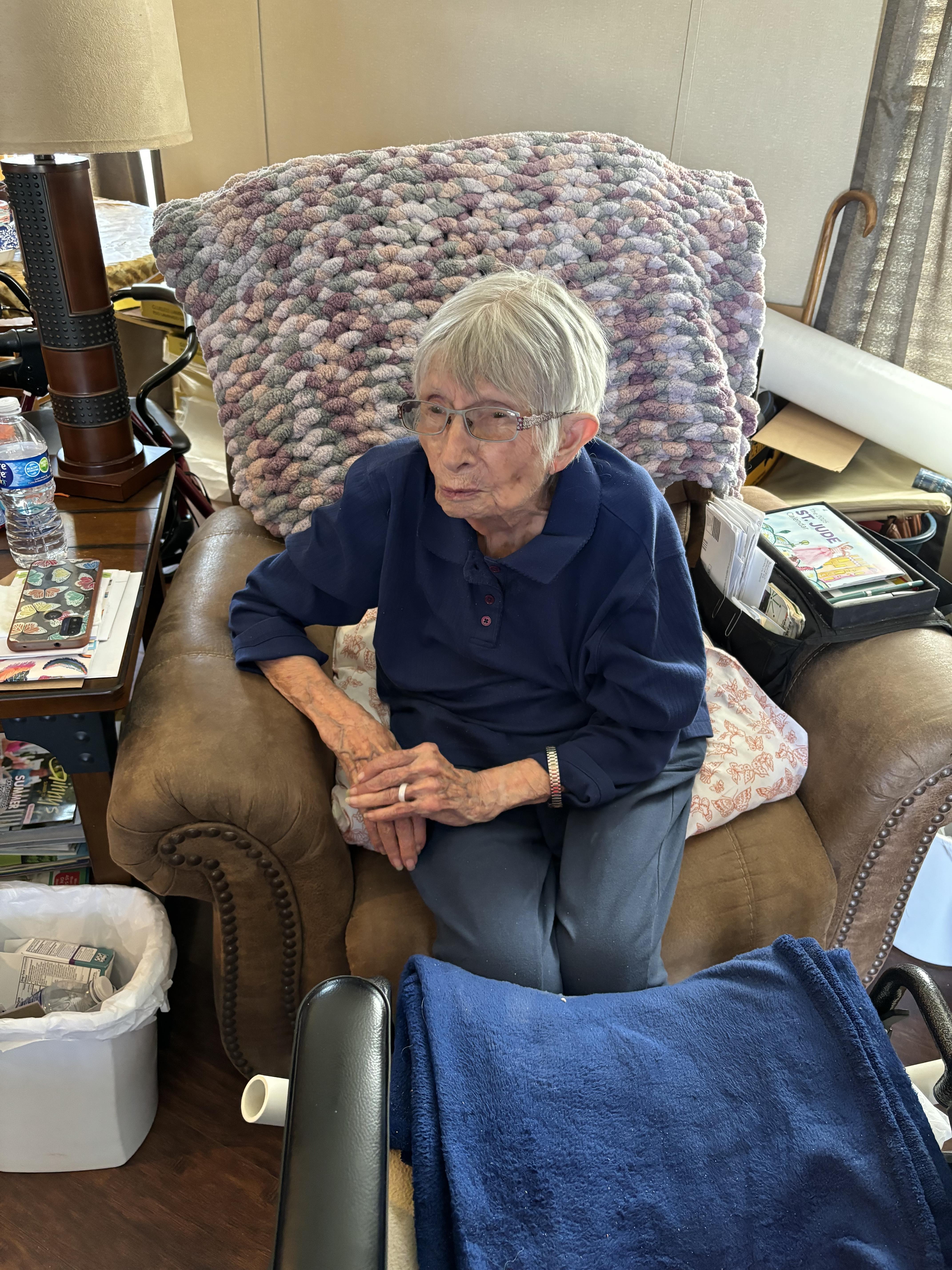 An old woman sitting in a chair