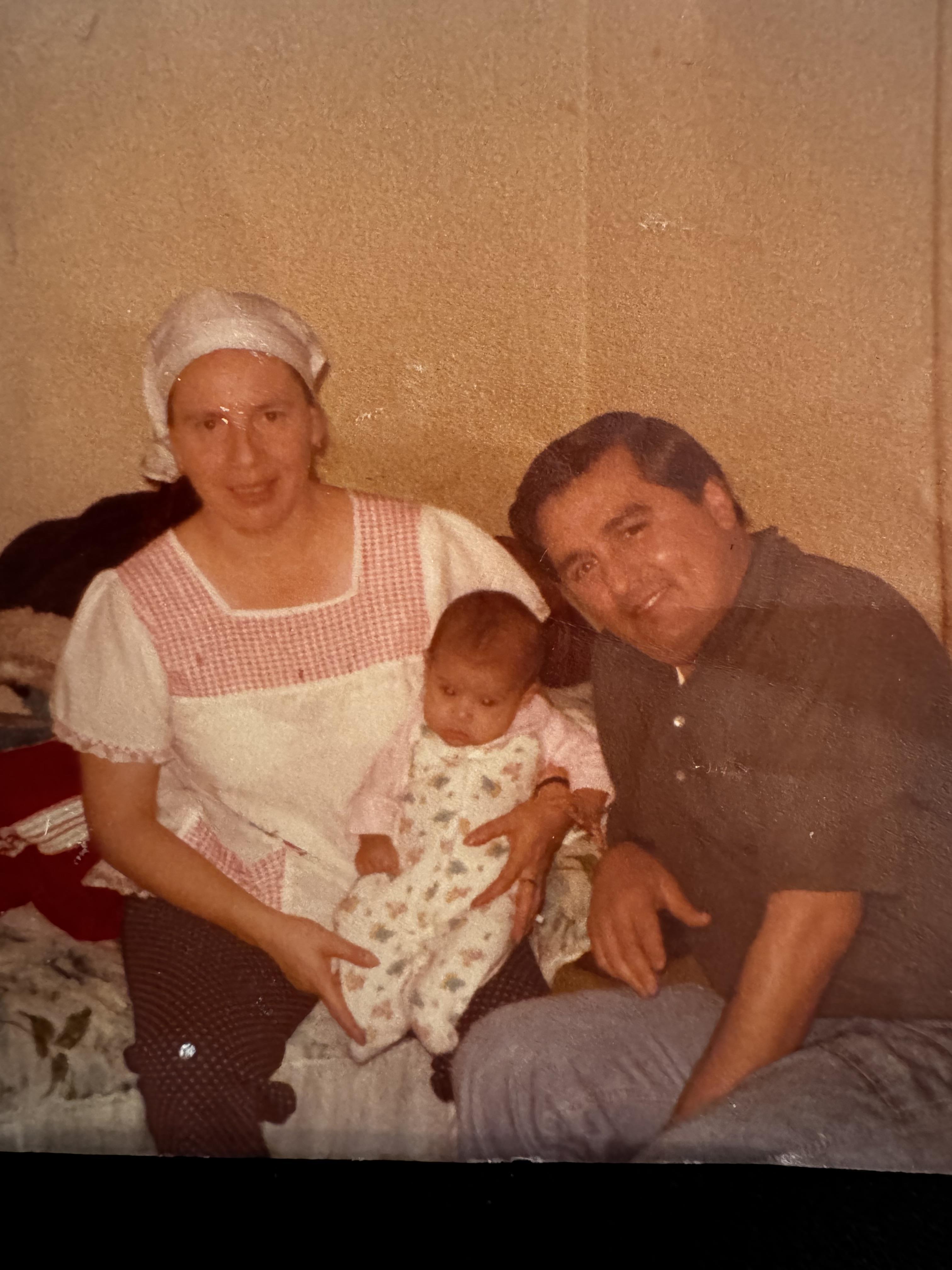 A man and woman holding a baby