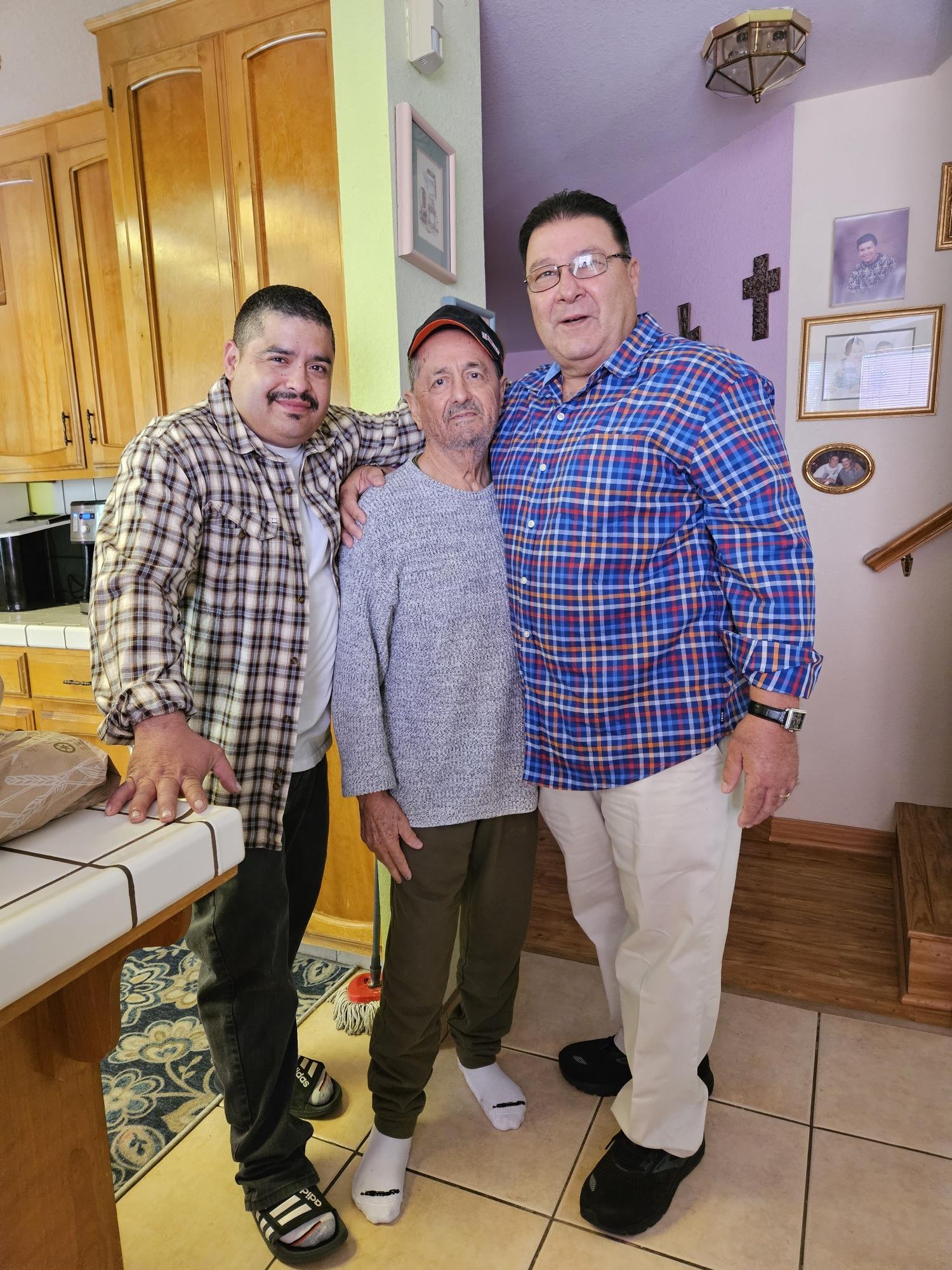 A group of men standing together in a kitchen