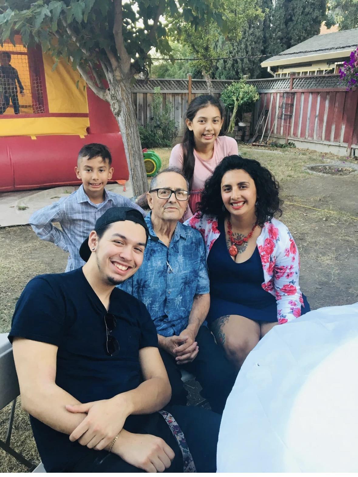A group of people sitting together outside