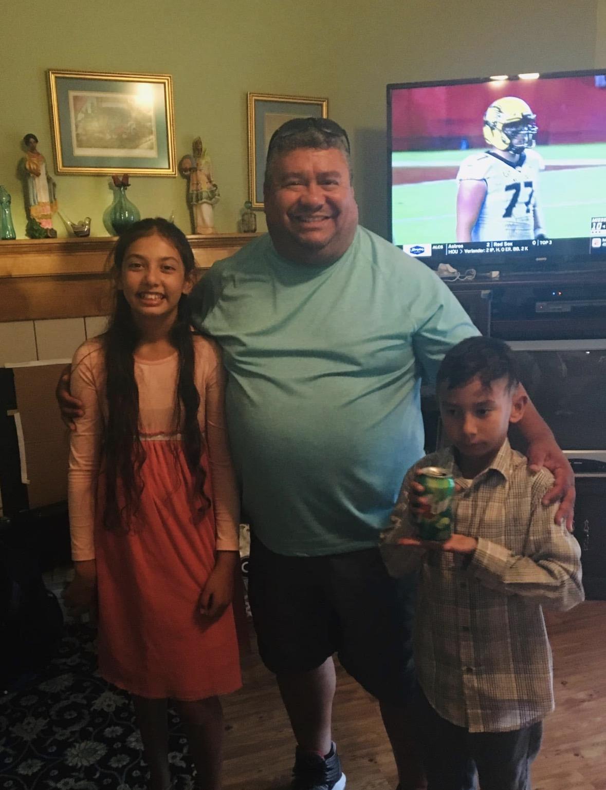 A man and two children posing for a picture