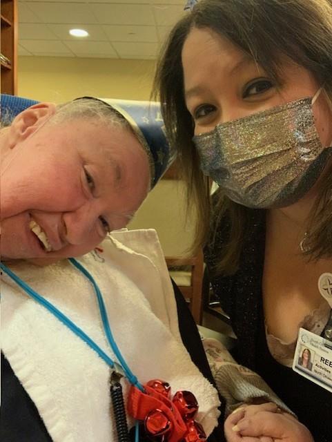 A woman with silver mask and a man wearing a white robe