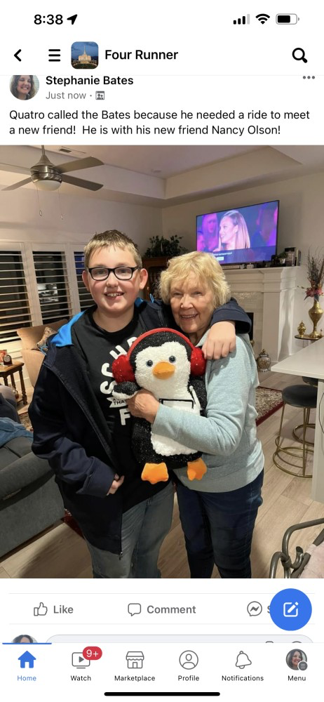 A woman and boy holding a stuffed penguin