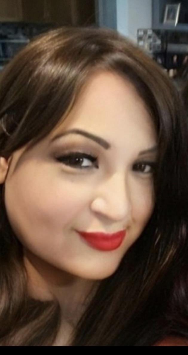 A woman with red lipstick smiling