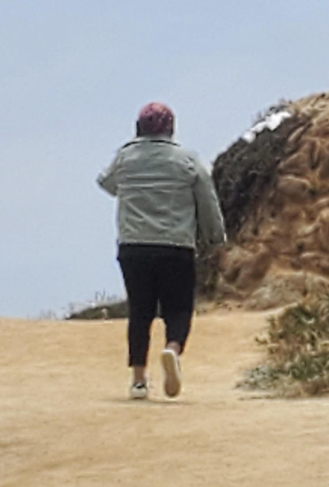 A person running on a sandy beach