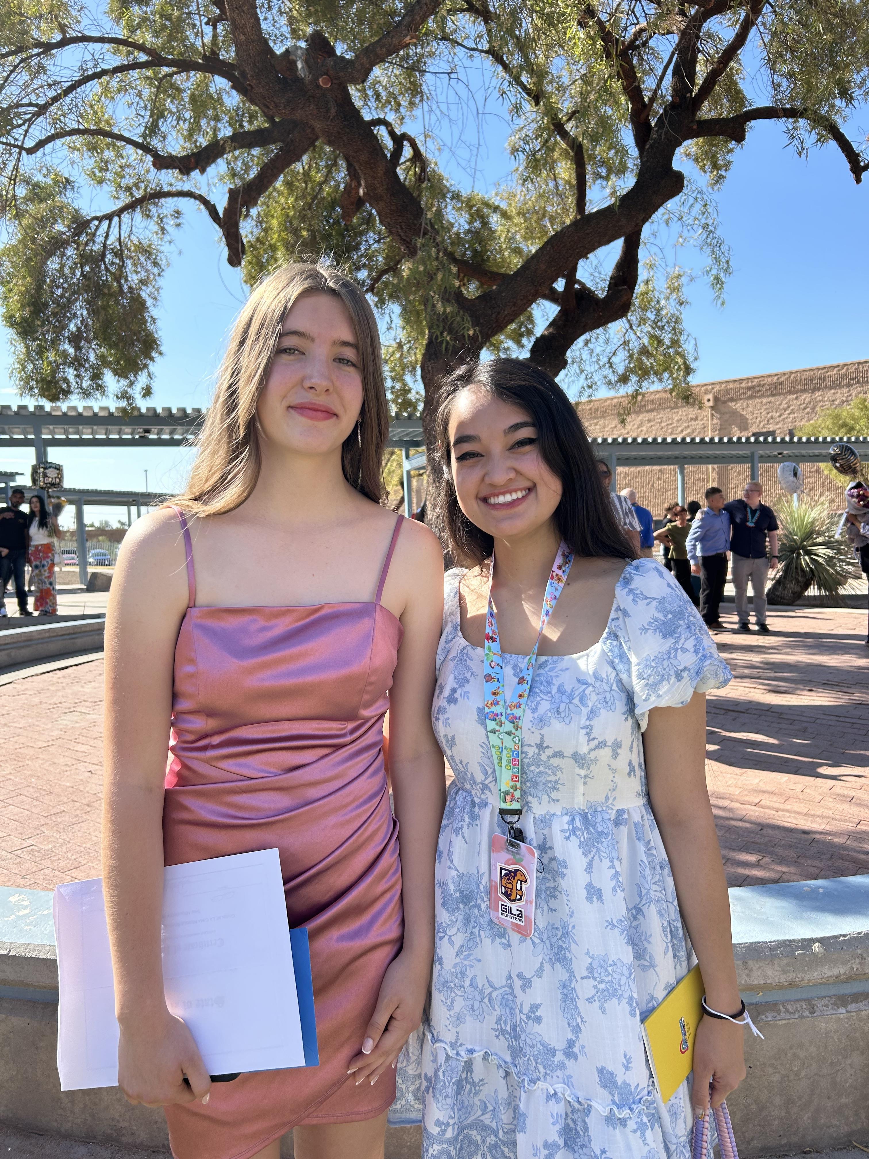 Two women standing together outside