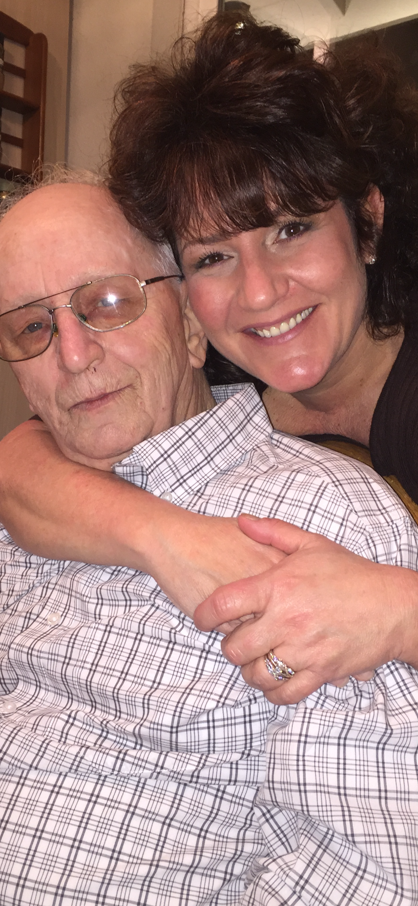 A woman hugging an old man