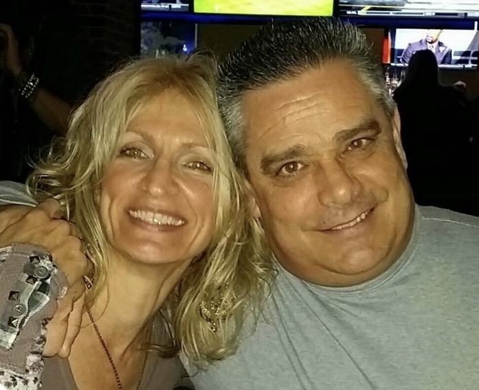 A man and woman smiling for a selfie