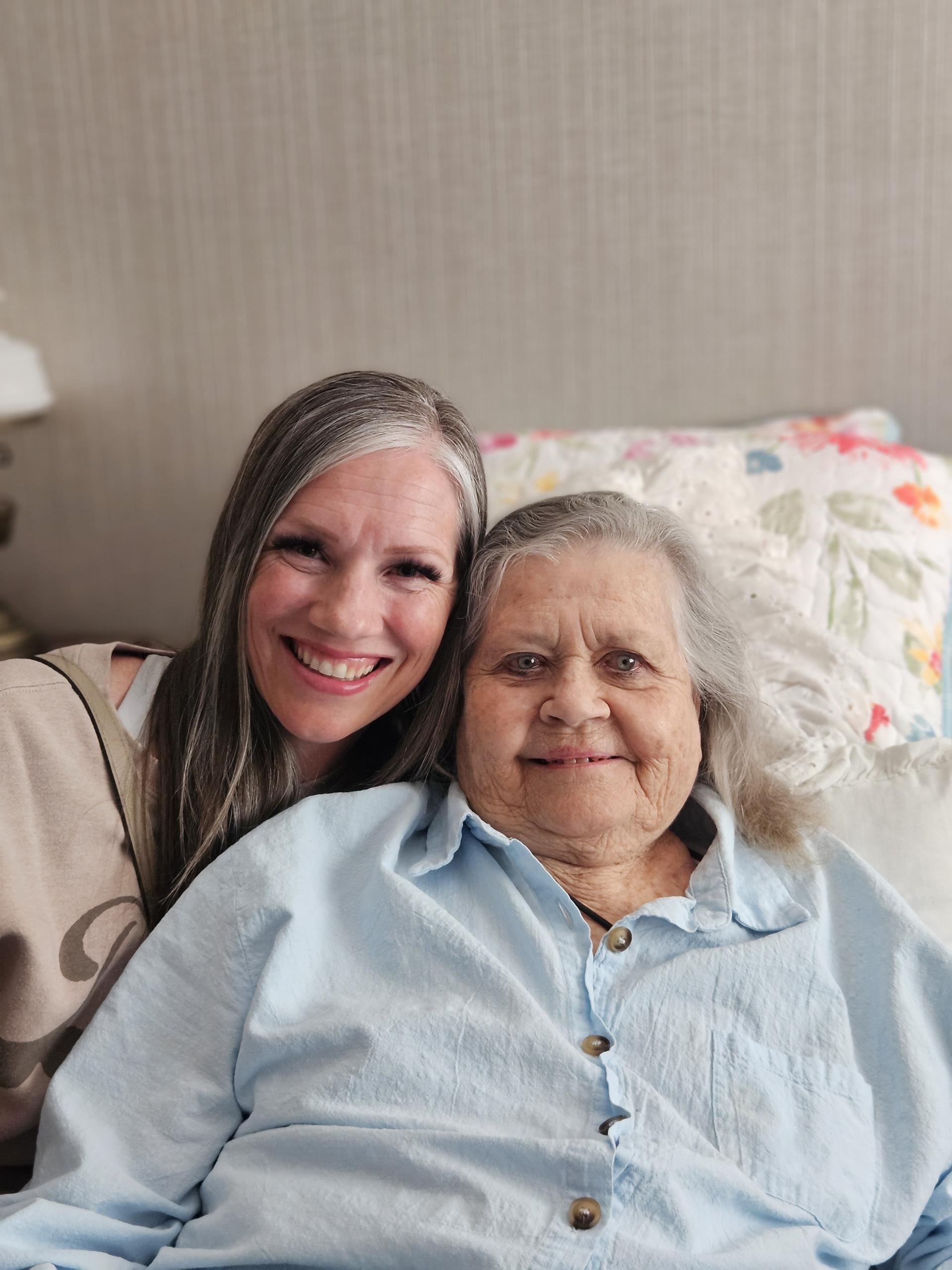 A woman and an older woman sitting on a couch