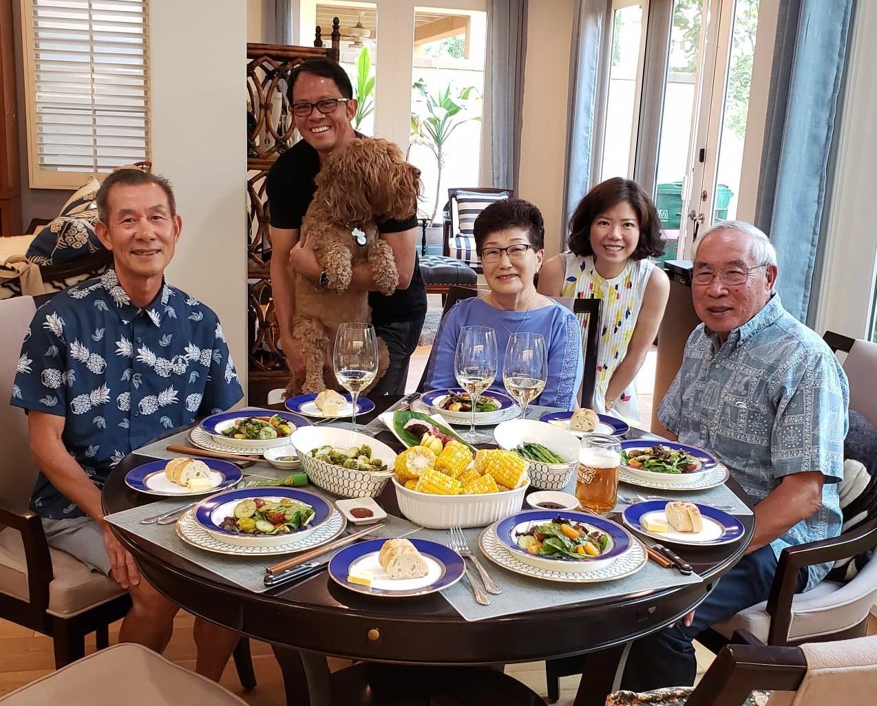 A group of people sitting at a table with food