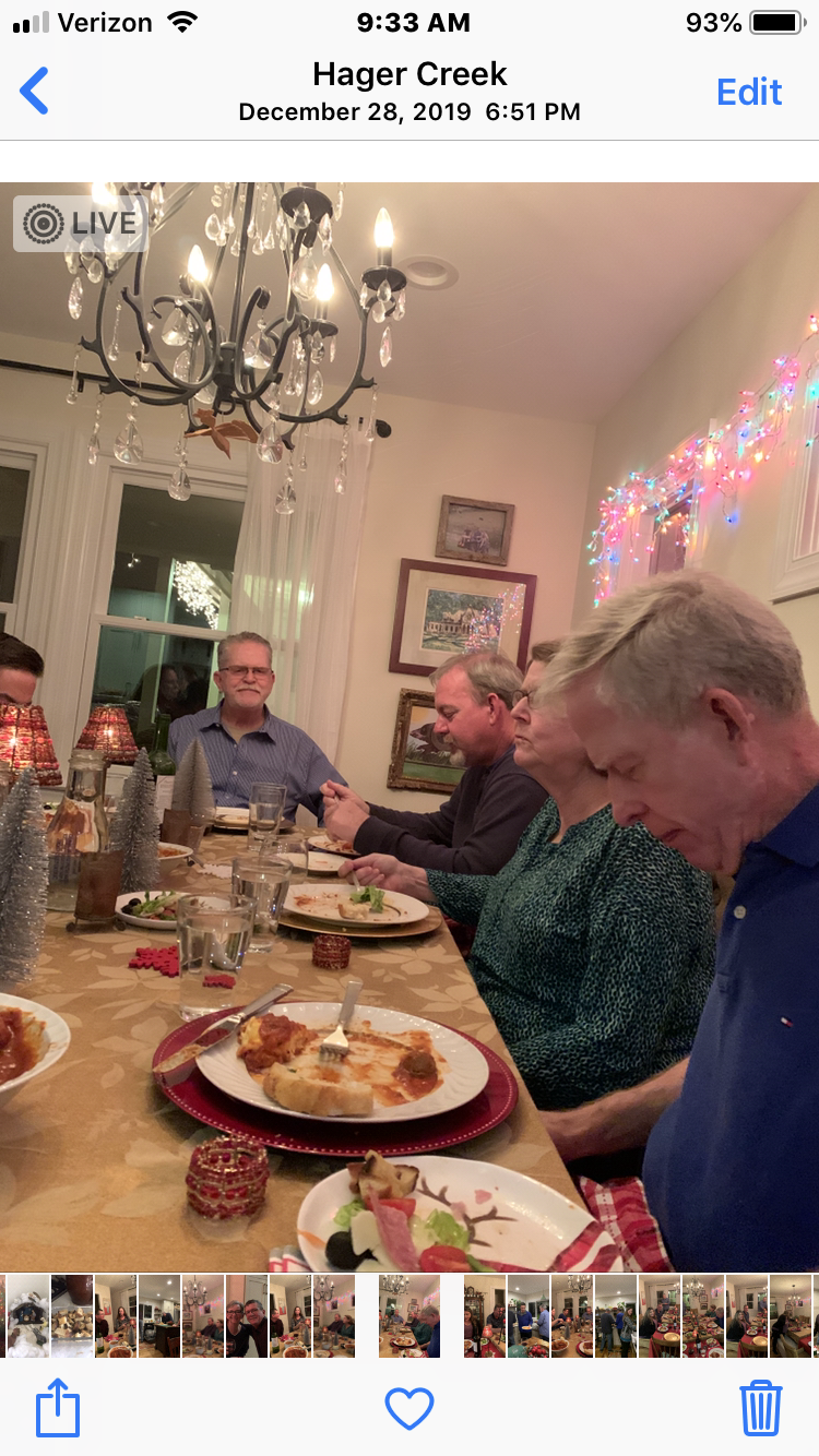 A group of people sitting at a table with plates of food
