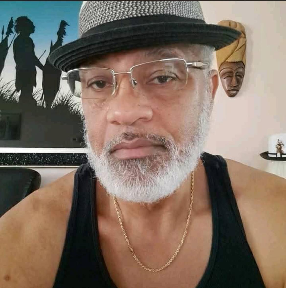 A man wearing a hat and glasses
