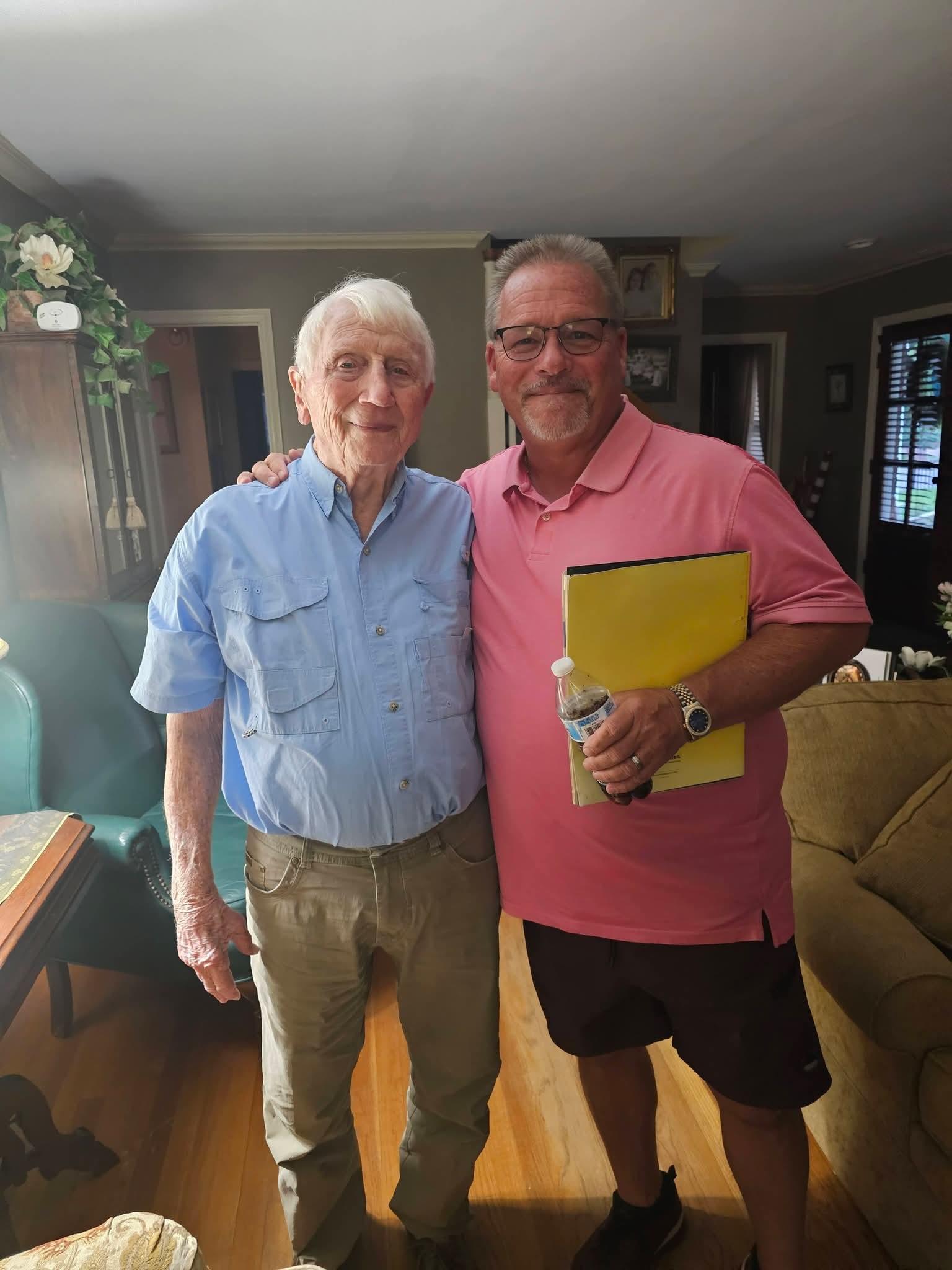 Two men standing together smiling